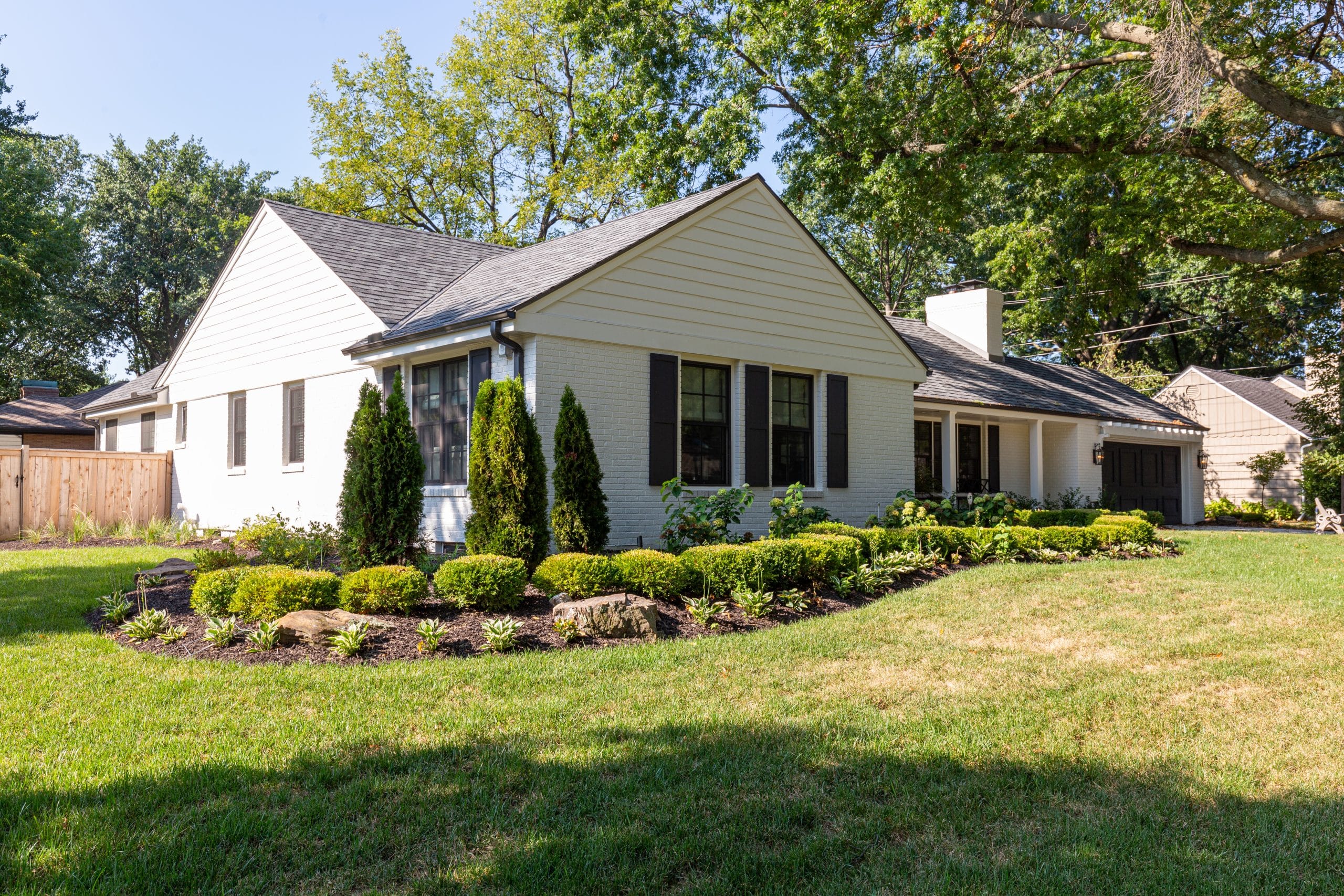 traditional ranch home in kansas city mission hills prairie village area with unique archicture elements like black shuttters