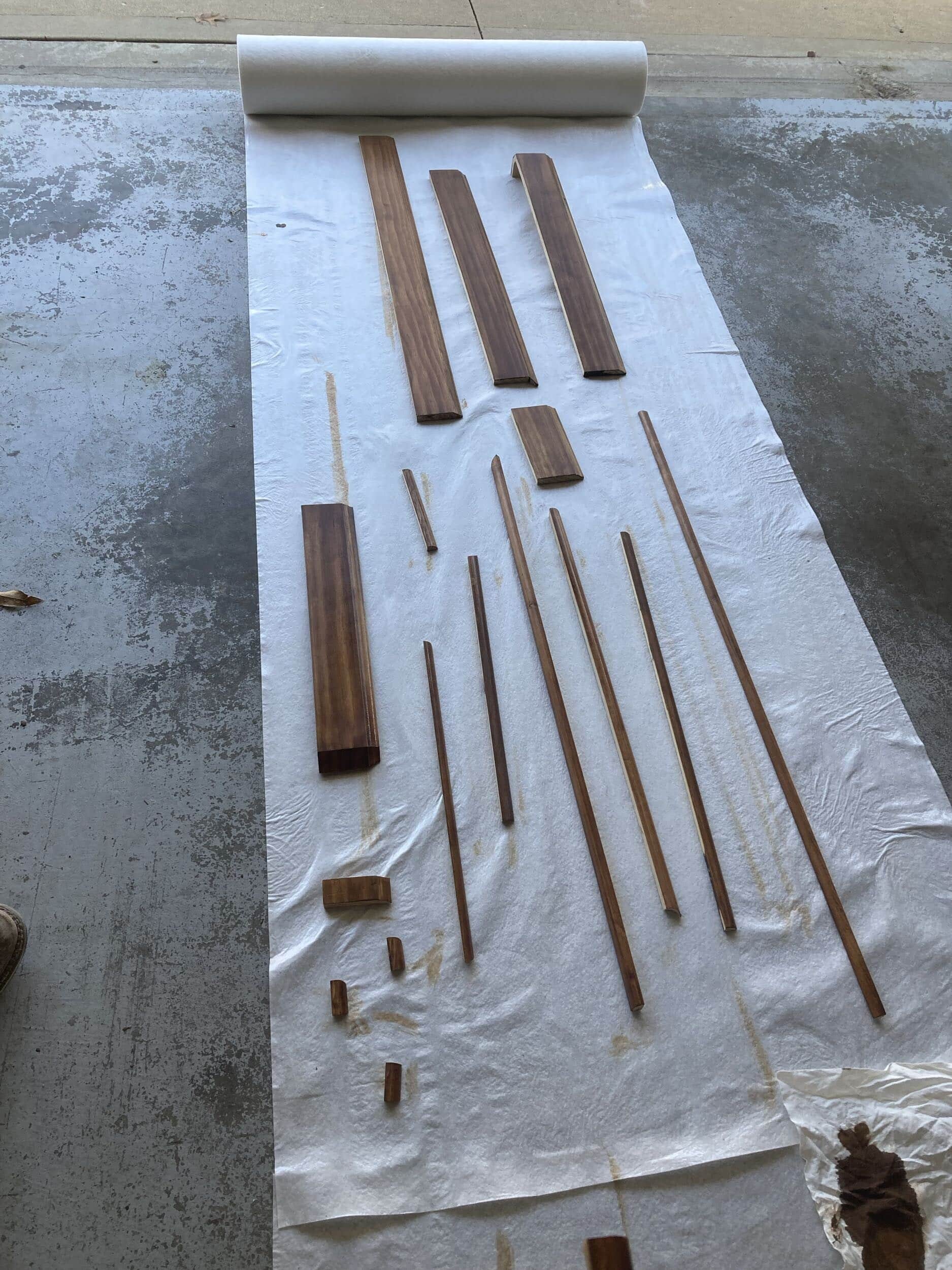 trim prep, various sized pieces of trim cut and stained and layed out on the floor