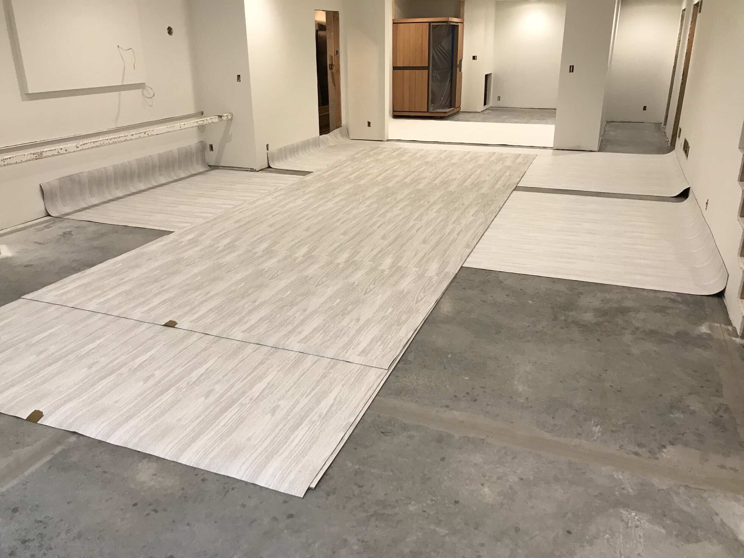 new floors being laid on the concrete floors of the leawood basement project
