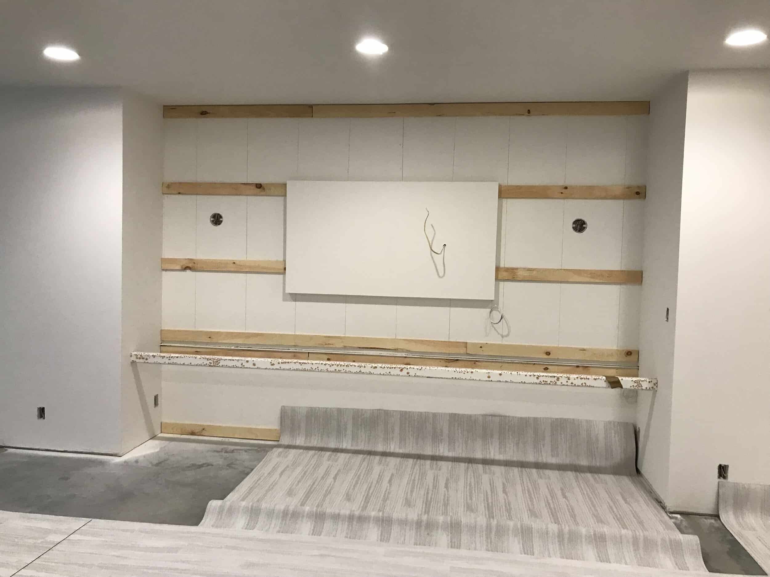 floor material laid out on the leawood concrete floor about to be glued and installed