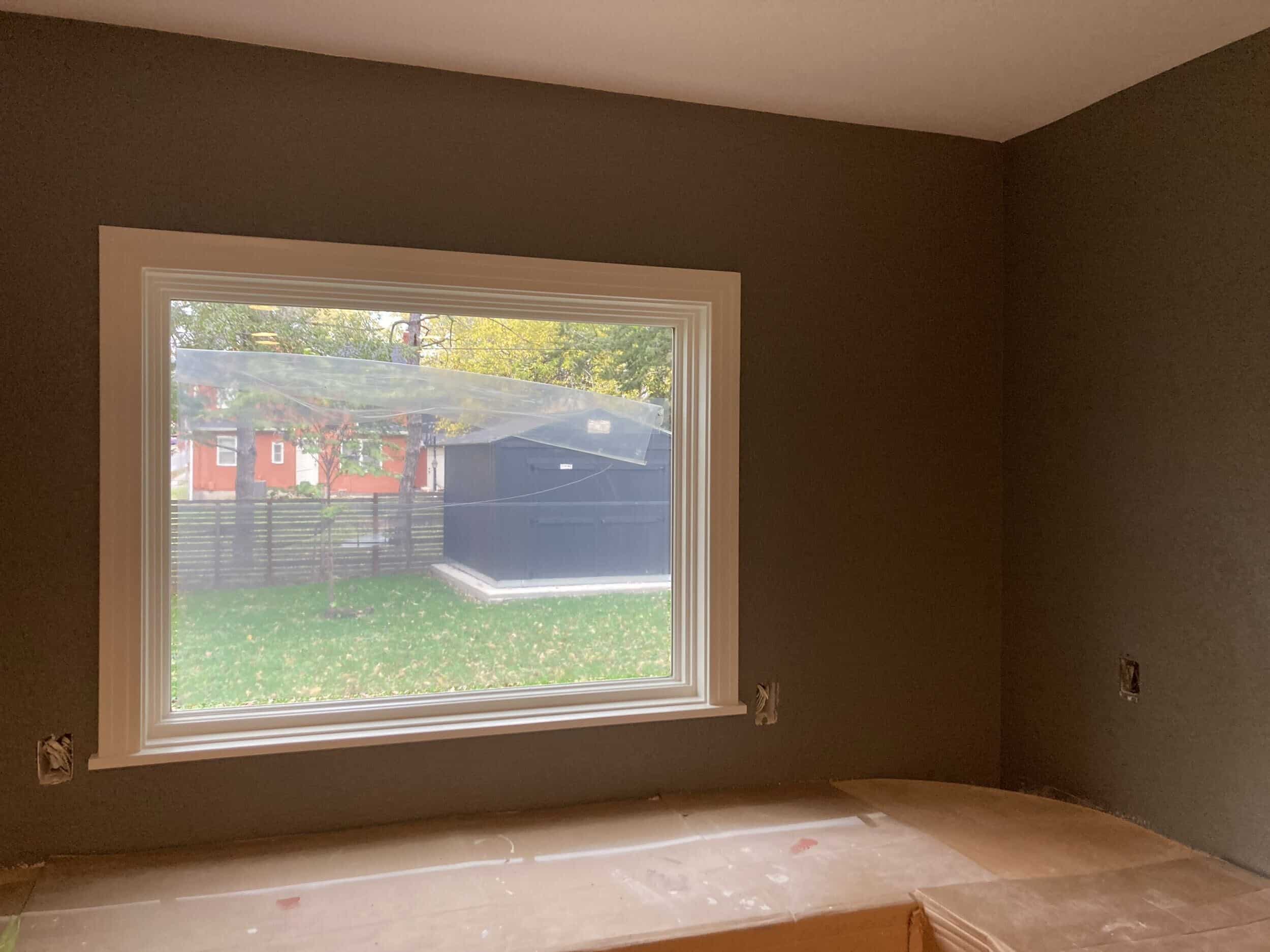 trim added around the new window and dark grey texture and paint on the walls