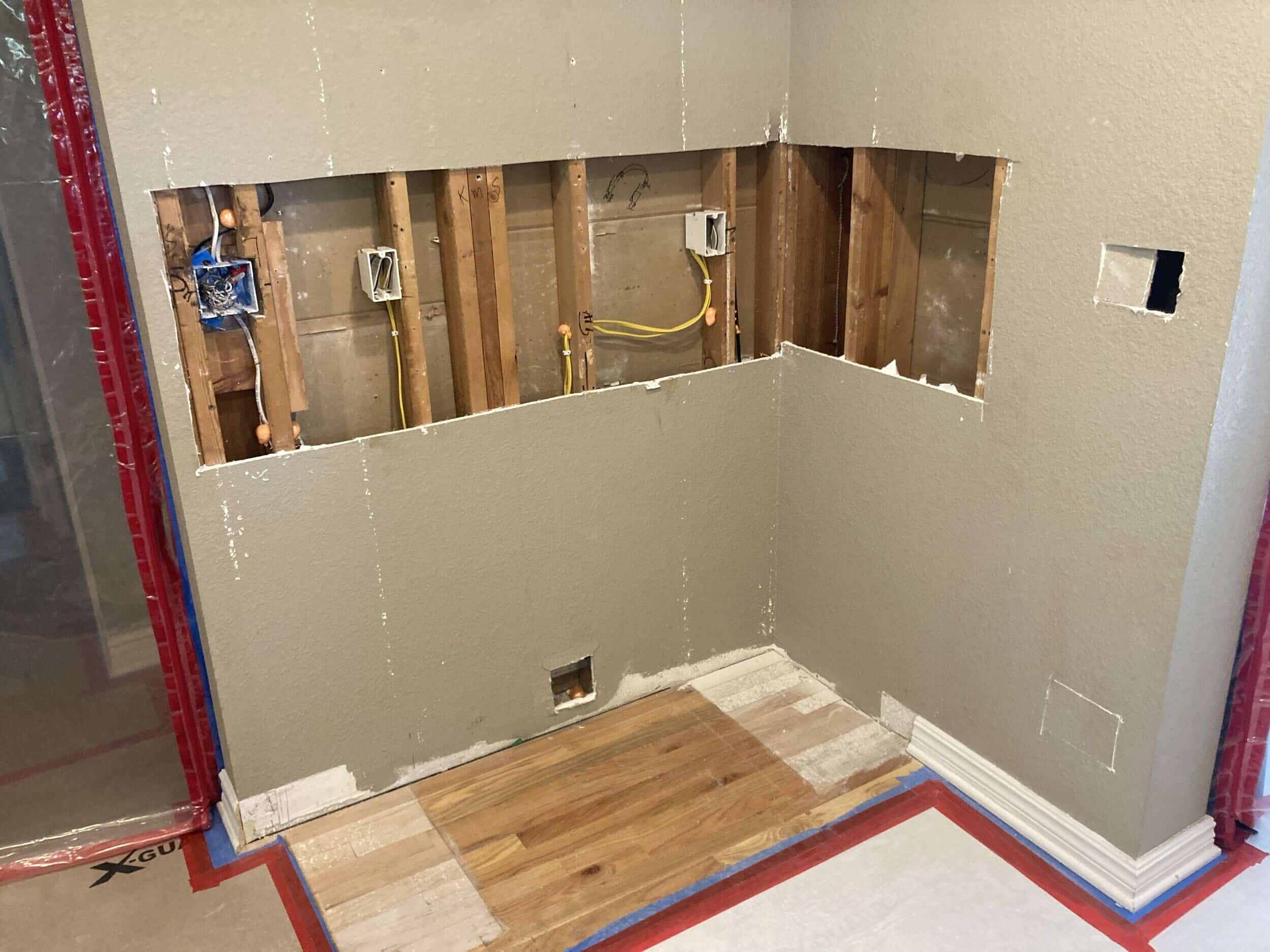 kitchen ddrywall demo progress exposing the framing and insulation and electrical