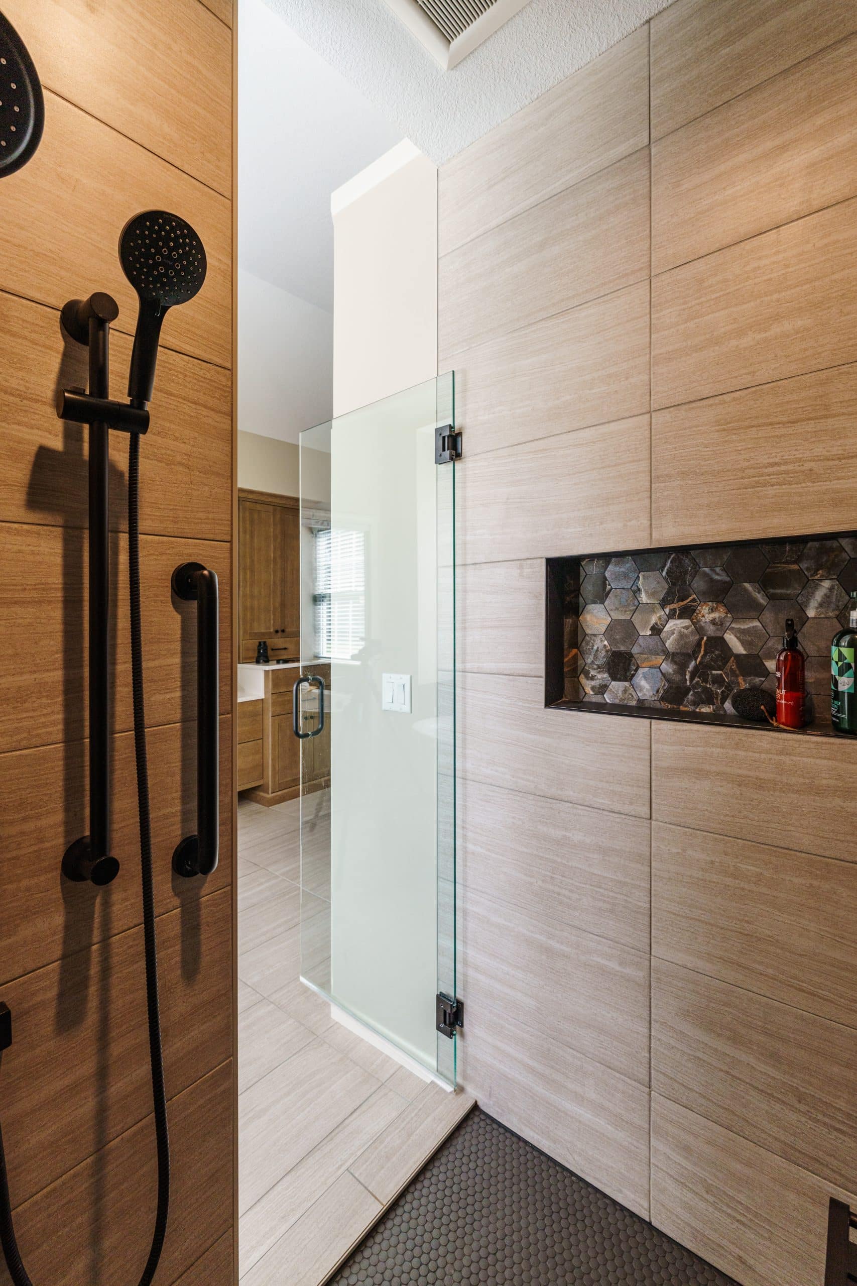 tradtional hinge swinging shower door opened into bathroom shot from insdie the shower 