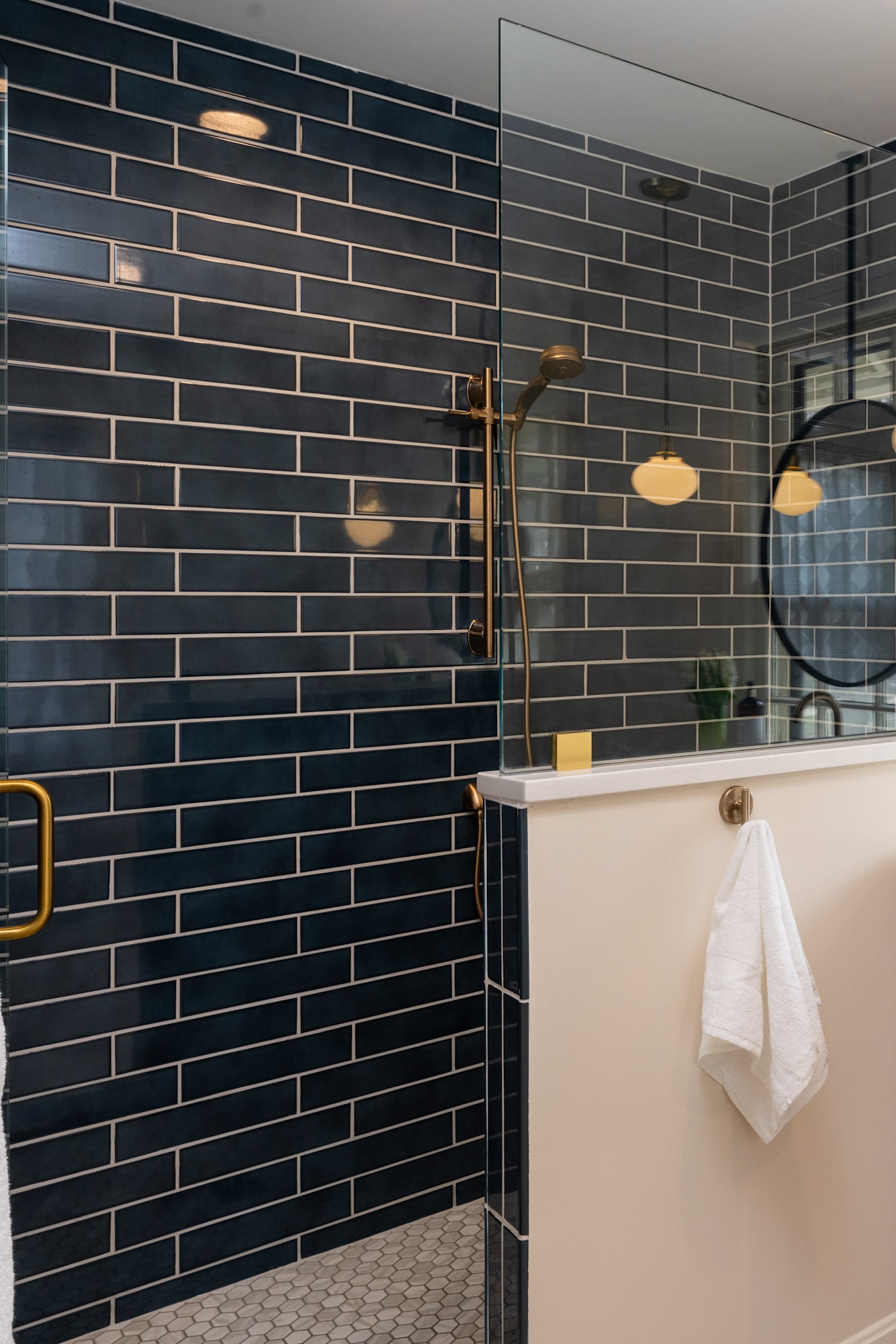pony wall with glass on top and a pivot glass shower door for the rest of the opening of the shower 