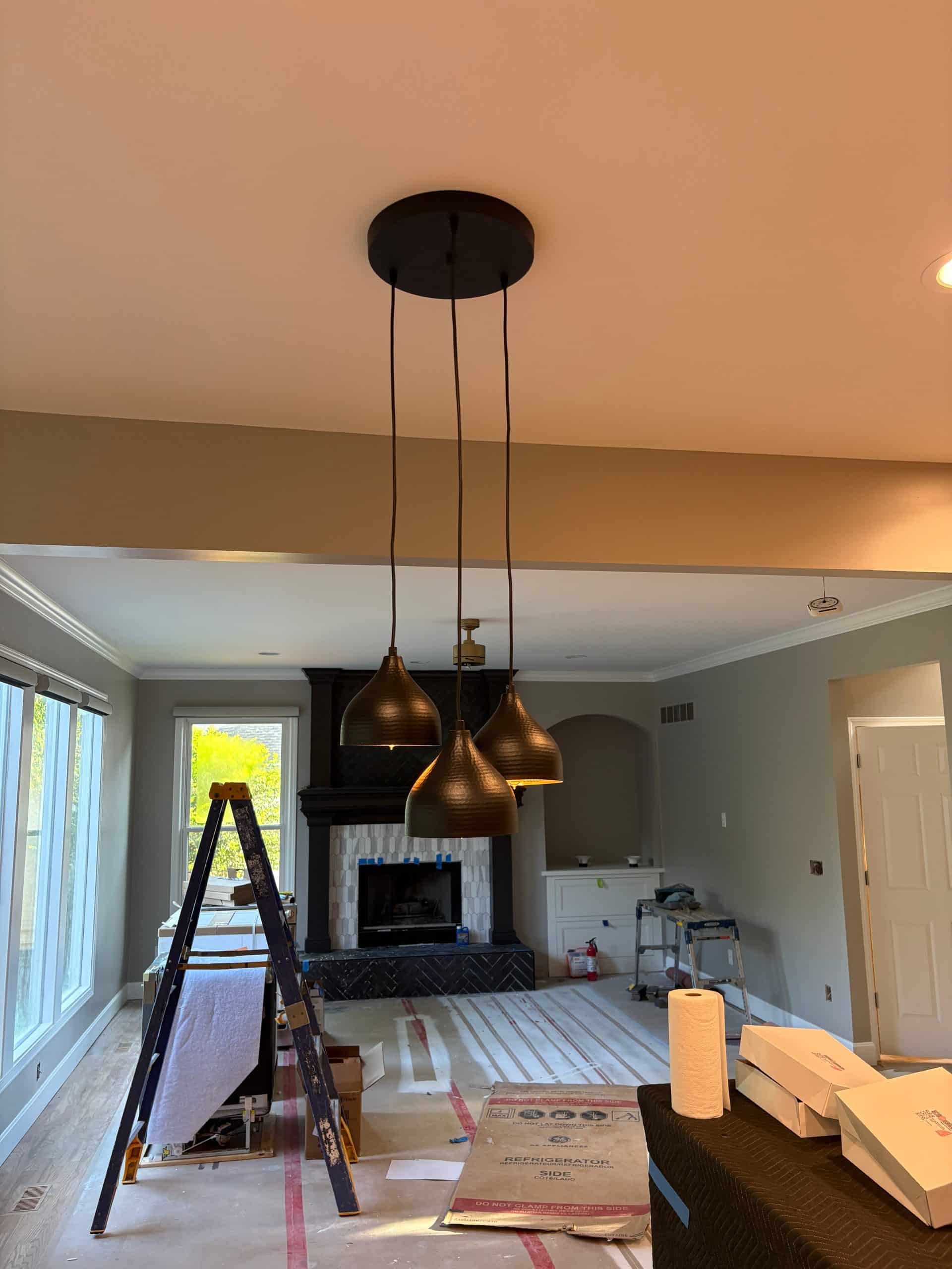 kitchen island light fixture with matte black textured finish with a gold interior 