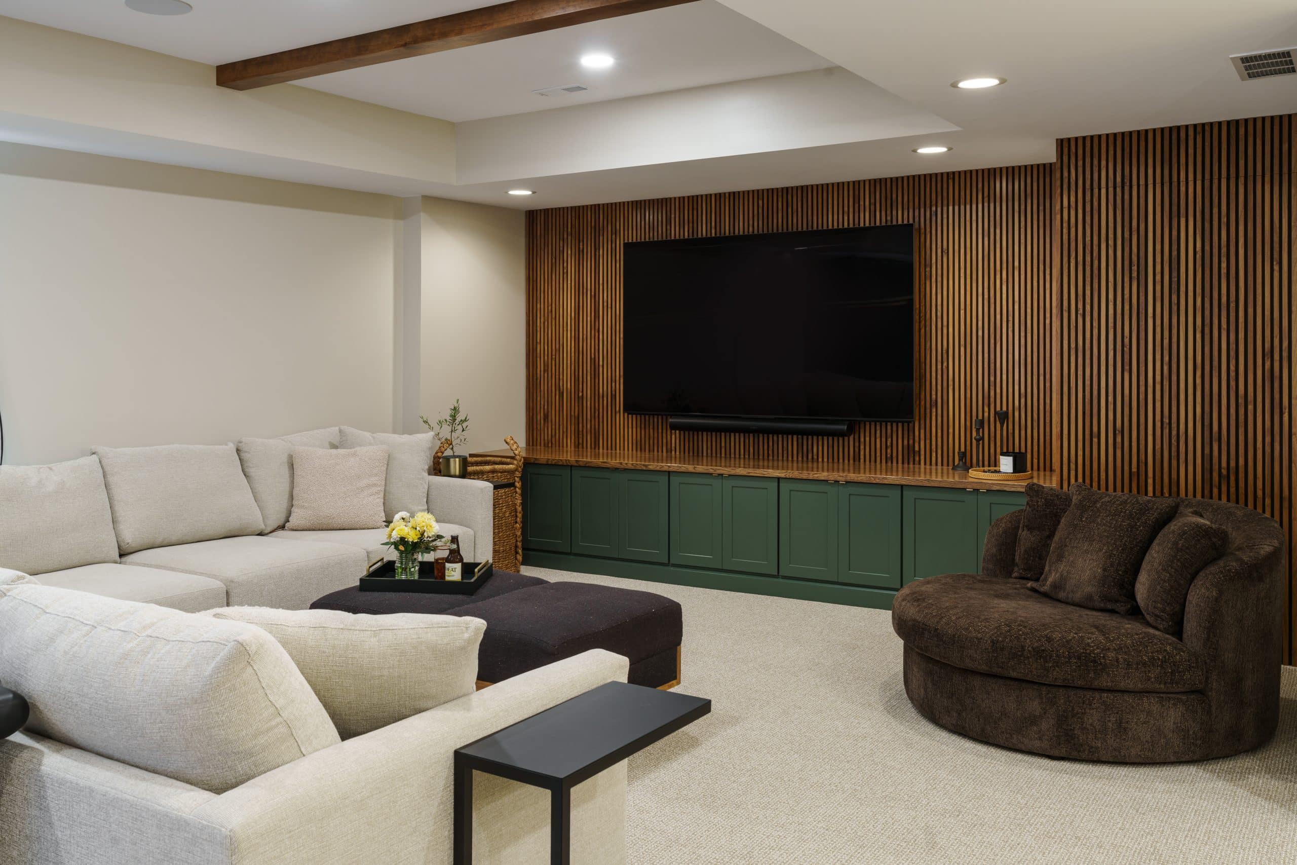 finished basement remodeling project with paneled stained accent feature media wall and cozy furniture to hang out on