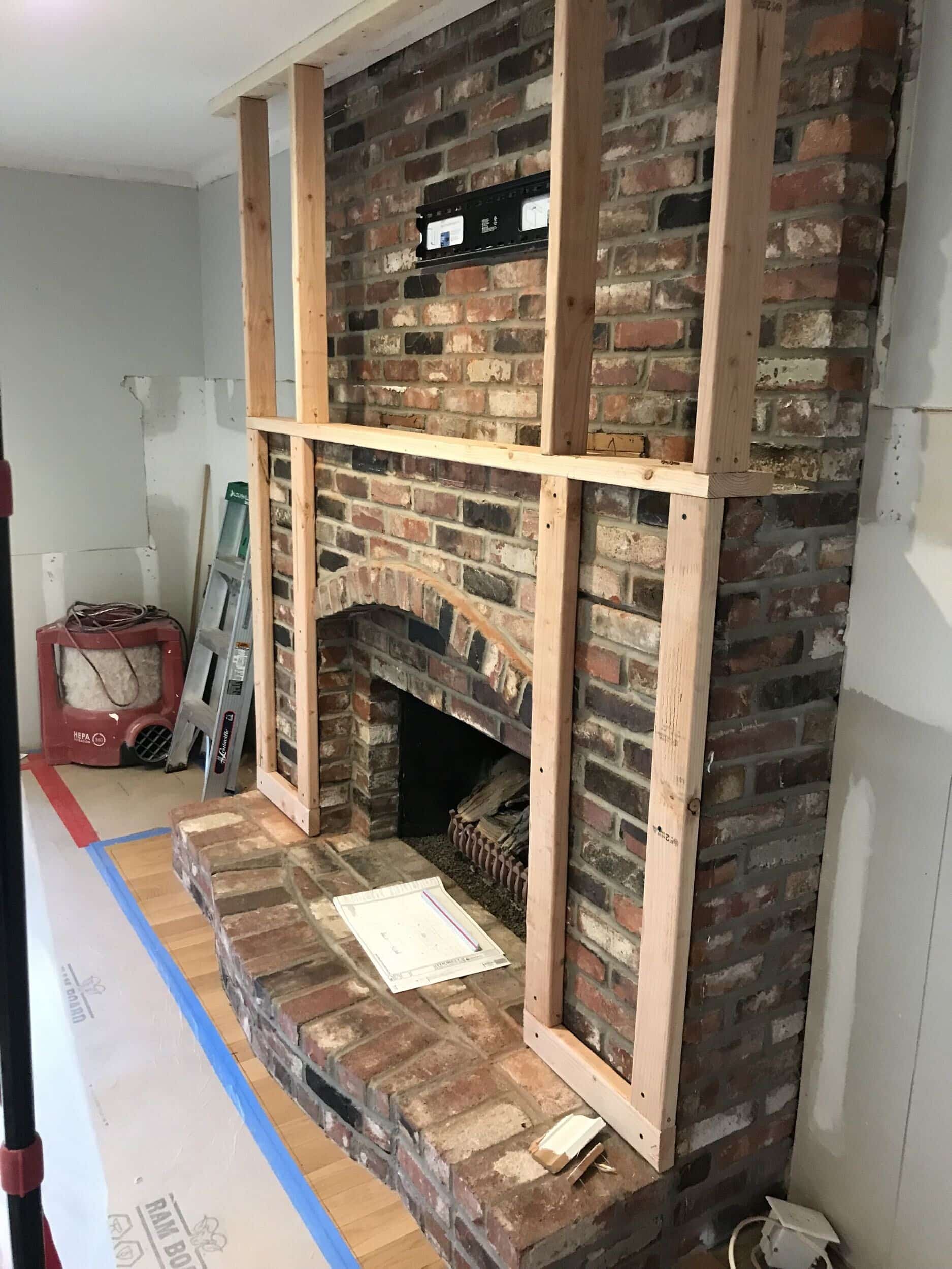 early  phases of framing on the existing brick fireplace prepping to be covered in concrete board and then plaser