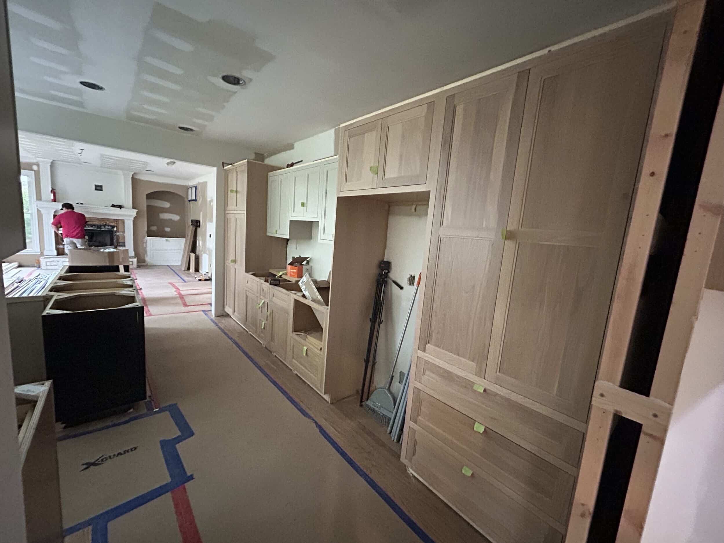 new white oak cabinets installed on a wall of the kitchen