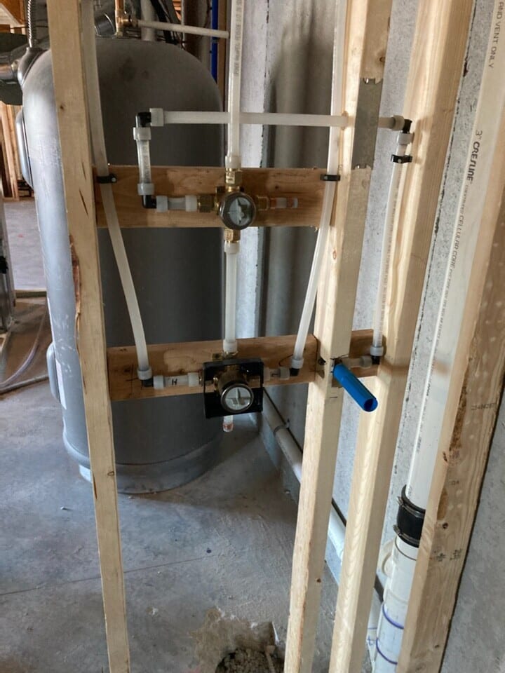 plumbing and water hook up for new basement kitchen and bathroom in plumbing and electrical rough in phase of construction for the basement remodel in Riverside