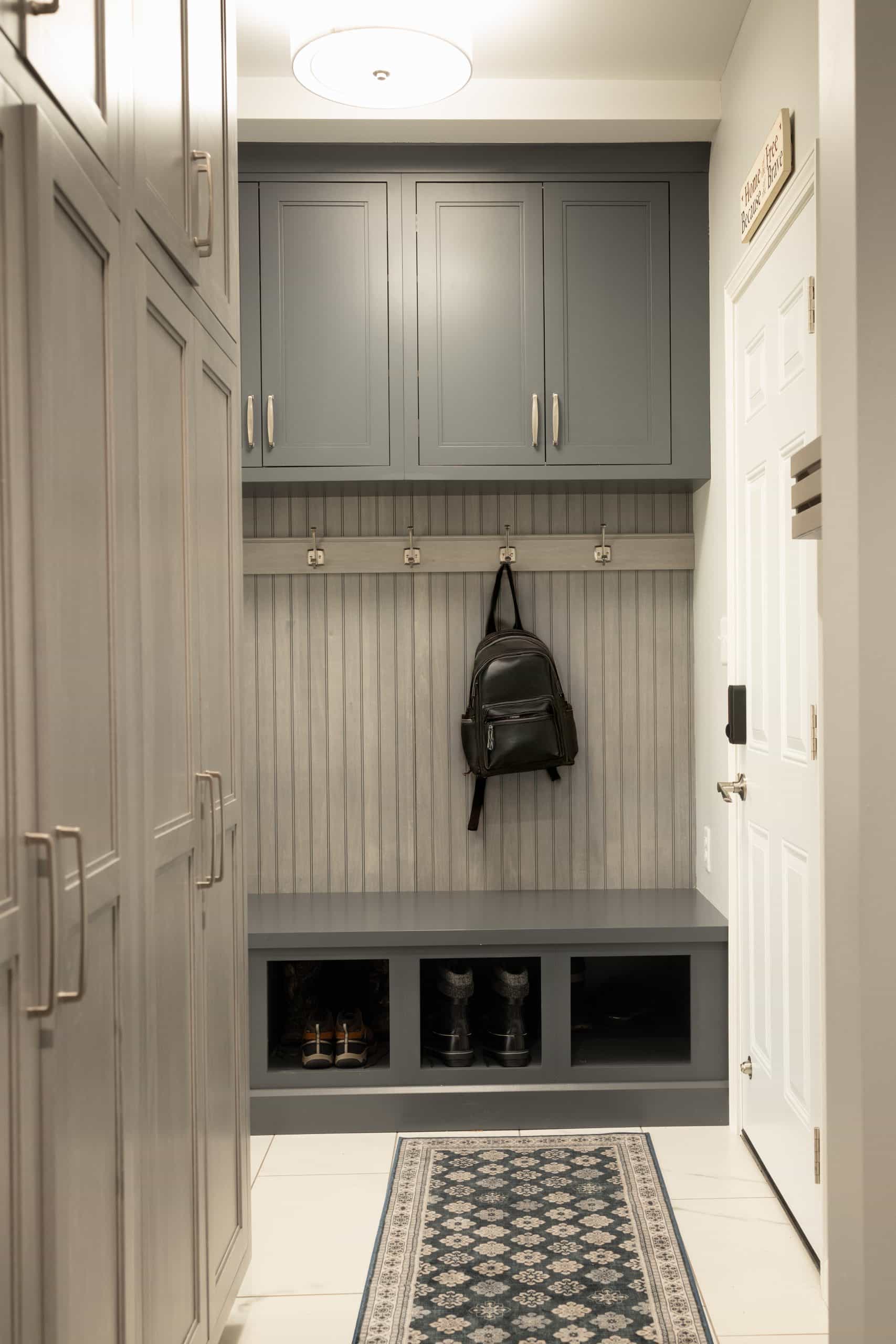 backpack drop zone with shoe storage right off entry from garage into home