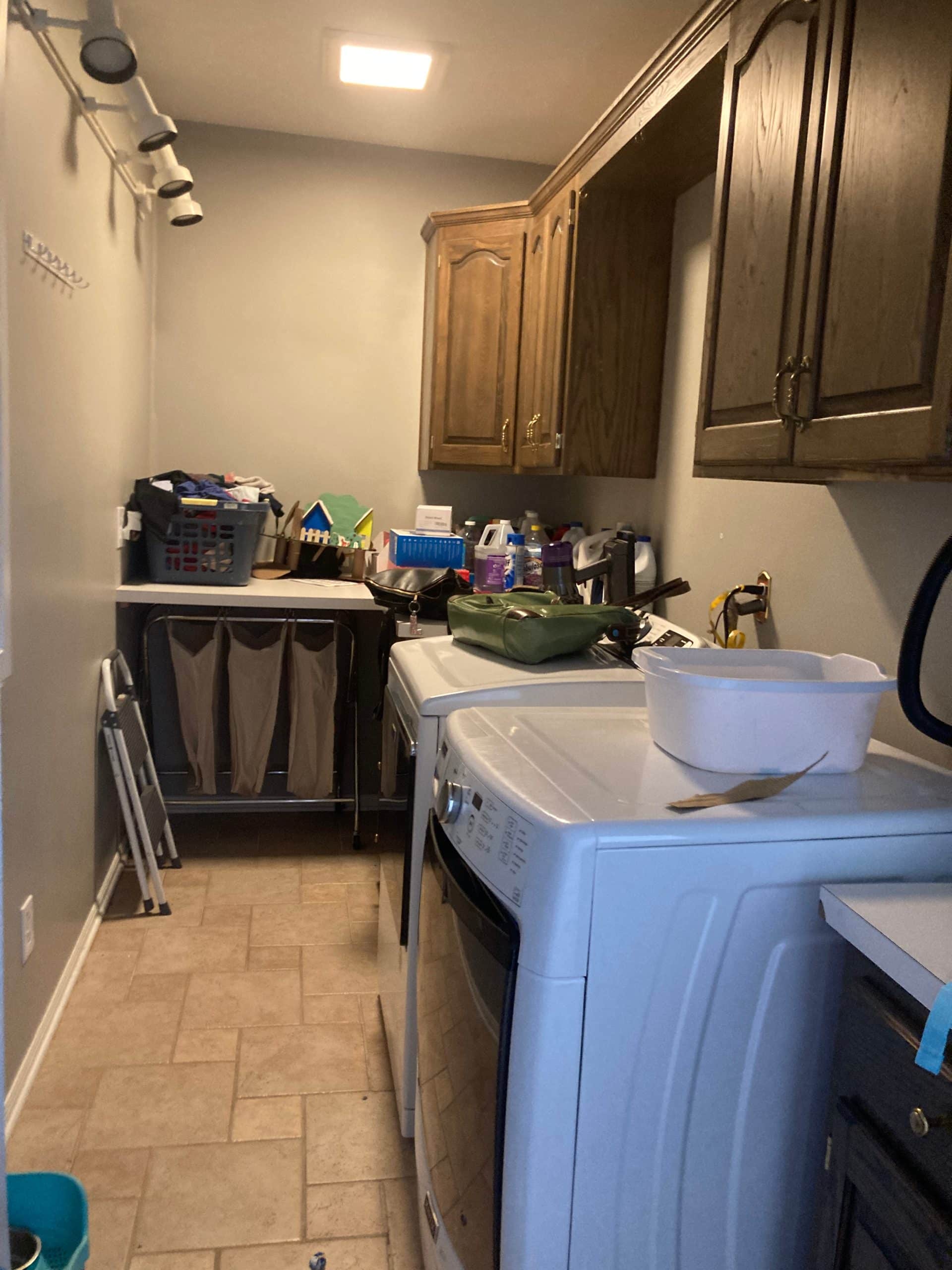 Before photo of dated, cluttered Lee's Summit mudroom laundry room