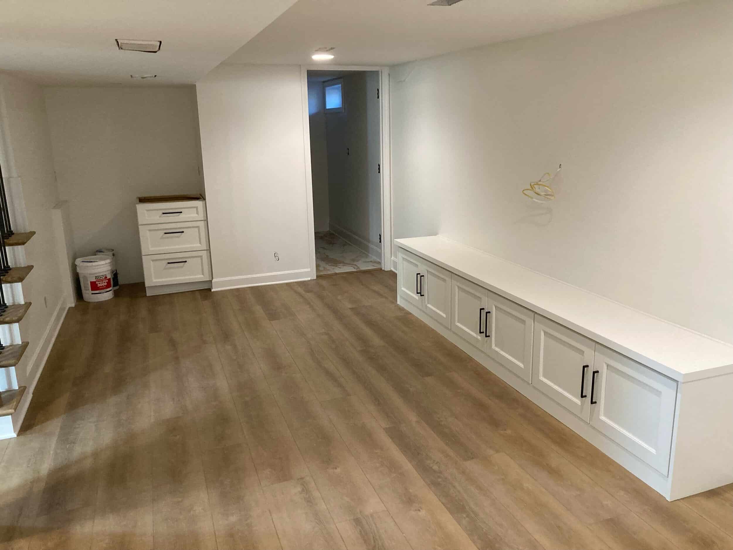 stain was chosen and placed on the floors. you can also see the built ins we added for storage under where the tv will be hung and near the beverage fridge station. 