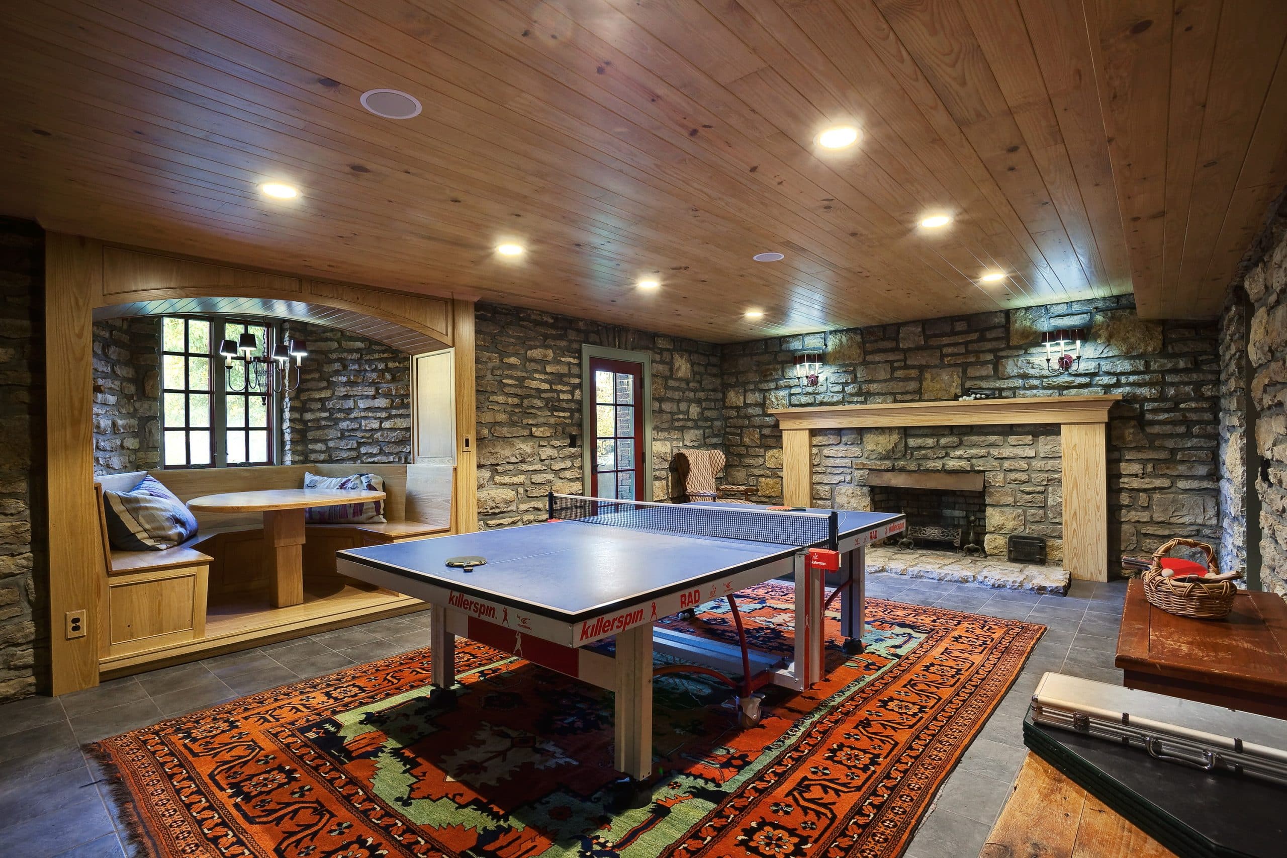 basement zone with ping pong and dining alcove perfect for guests who don't want to watch football but still want to hang out and be social
