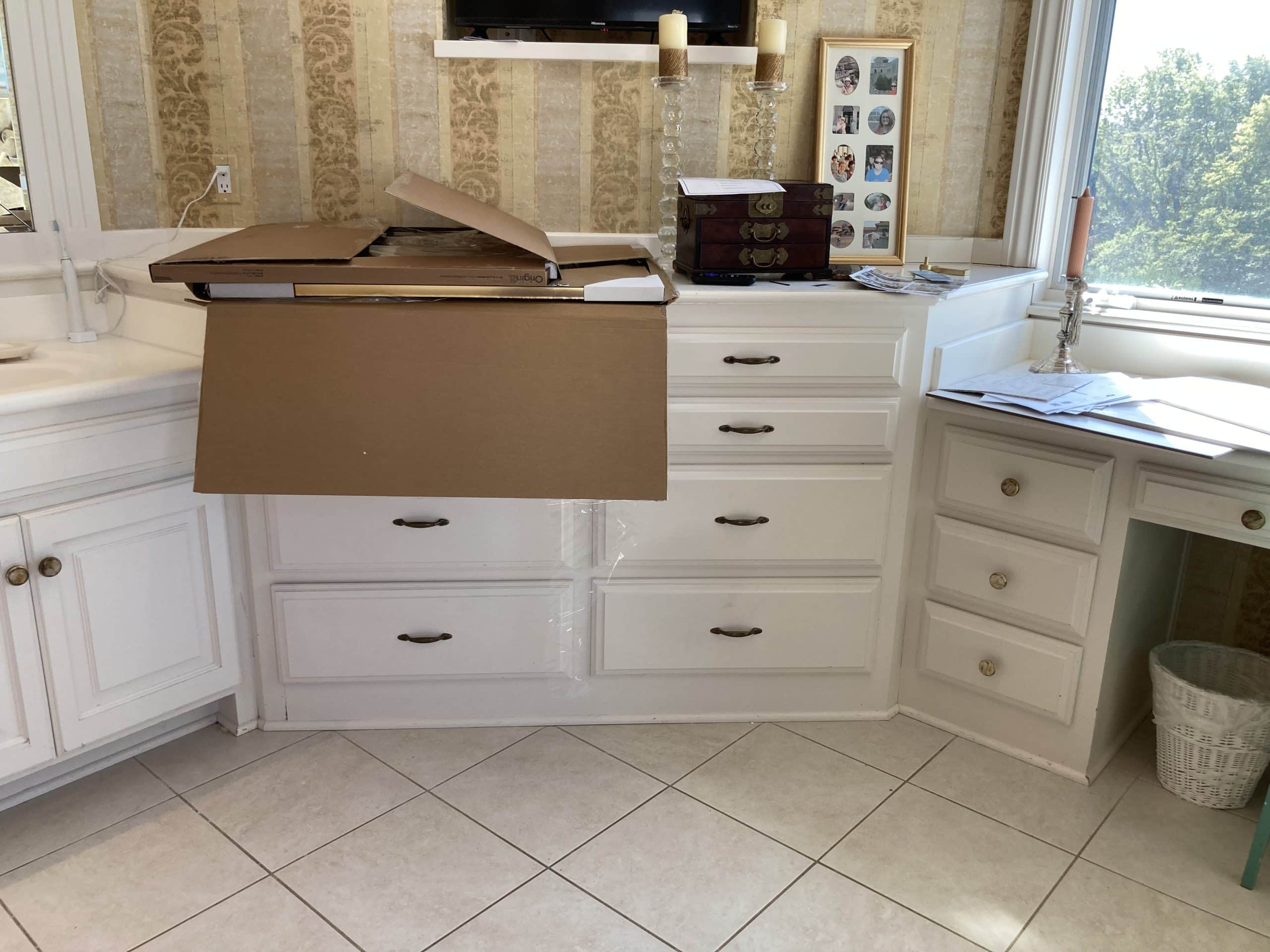existing cabinetry in a dated primary bathroom with all shades of cream and yellow and beige