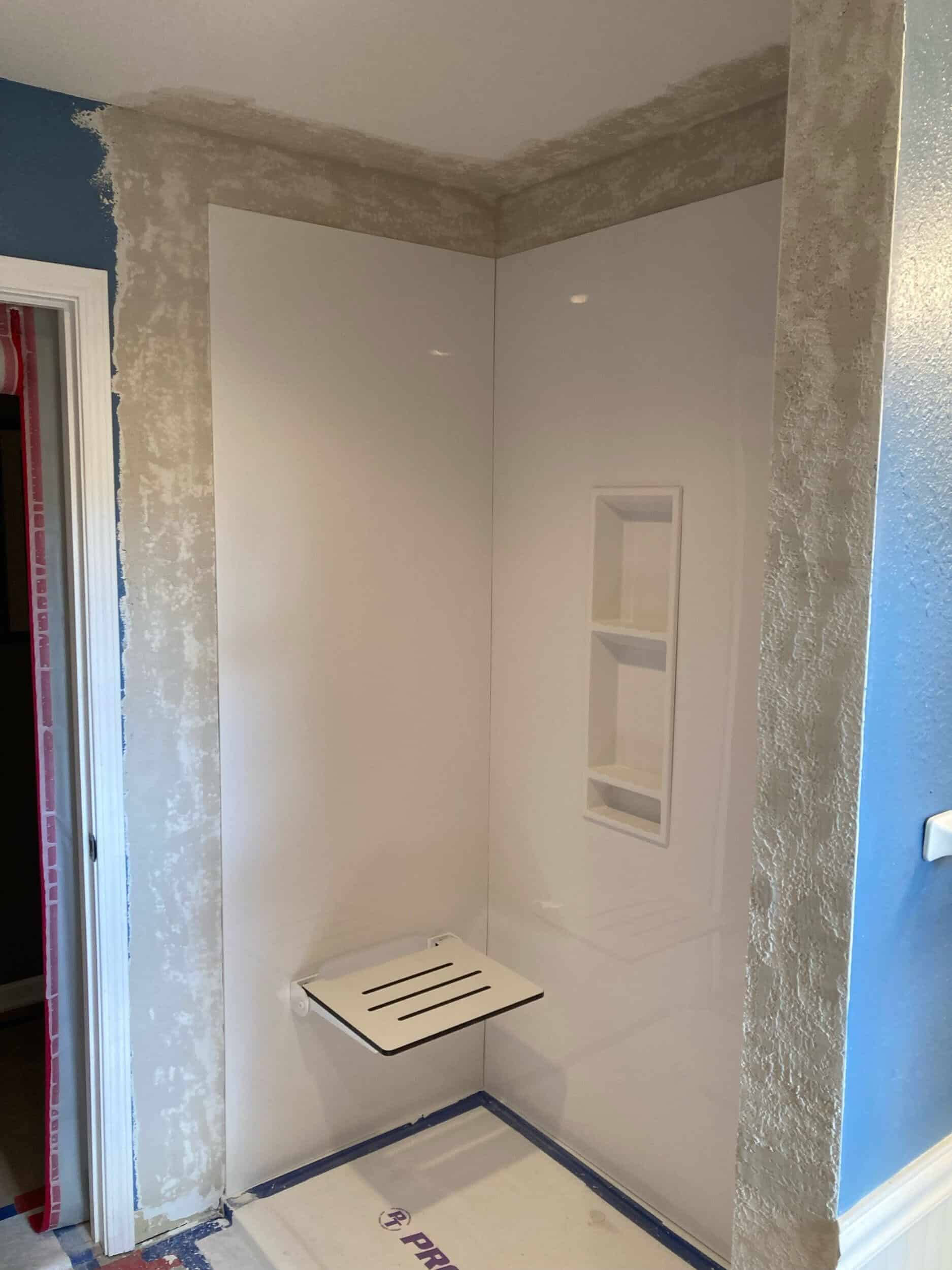 shower bench seat and niche for aging in place with grab bars added in shower remodel for aging in place at lake of hthe ozarks 