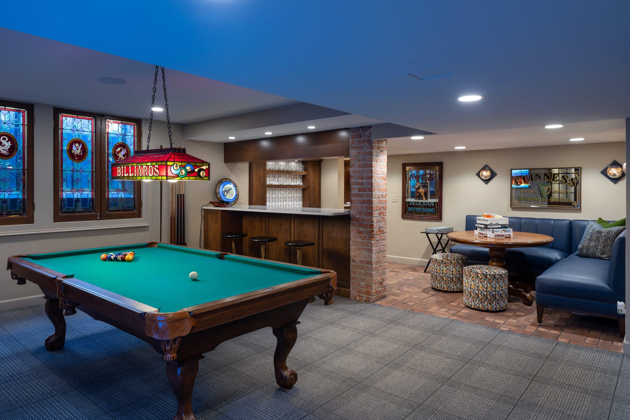 basement design that features a bar, pool table, dining corner and cool vintage english charm in the design details. remodeld basement in kansas city missouri area schloegel design remodel