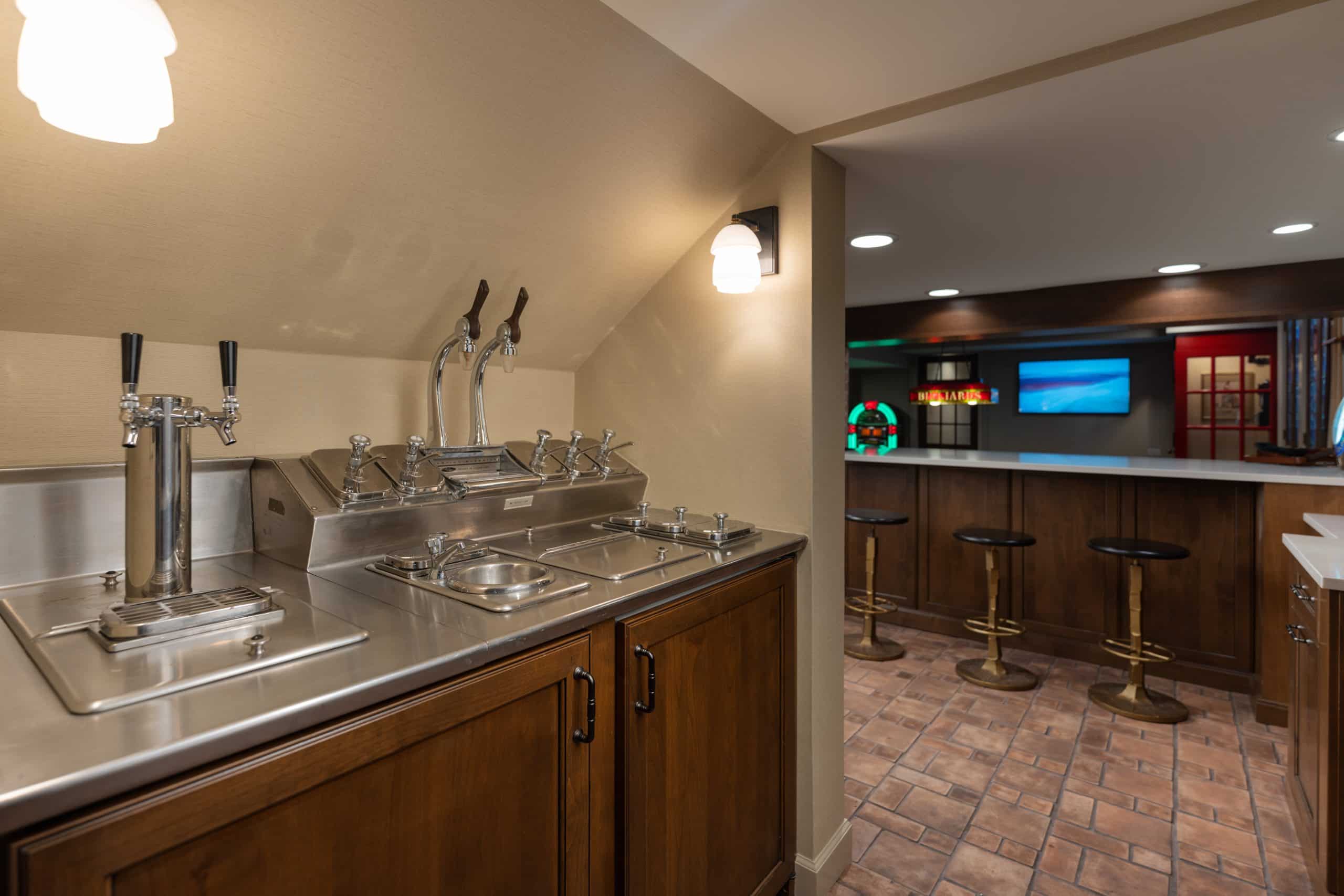 basement design that features a pub inpsired bar area with vintage charm in the design details. remodeld basement in kansas city missouri area schloegel design remodel