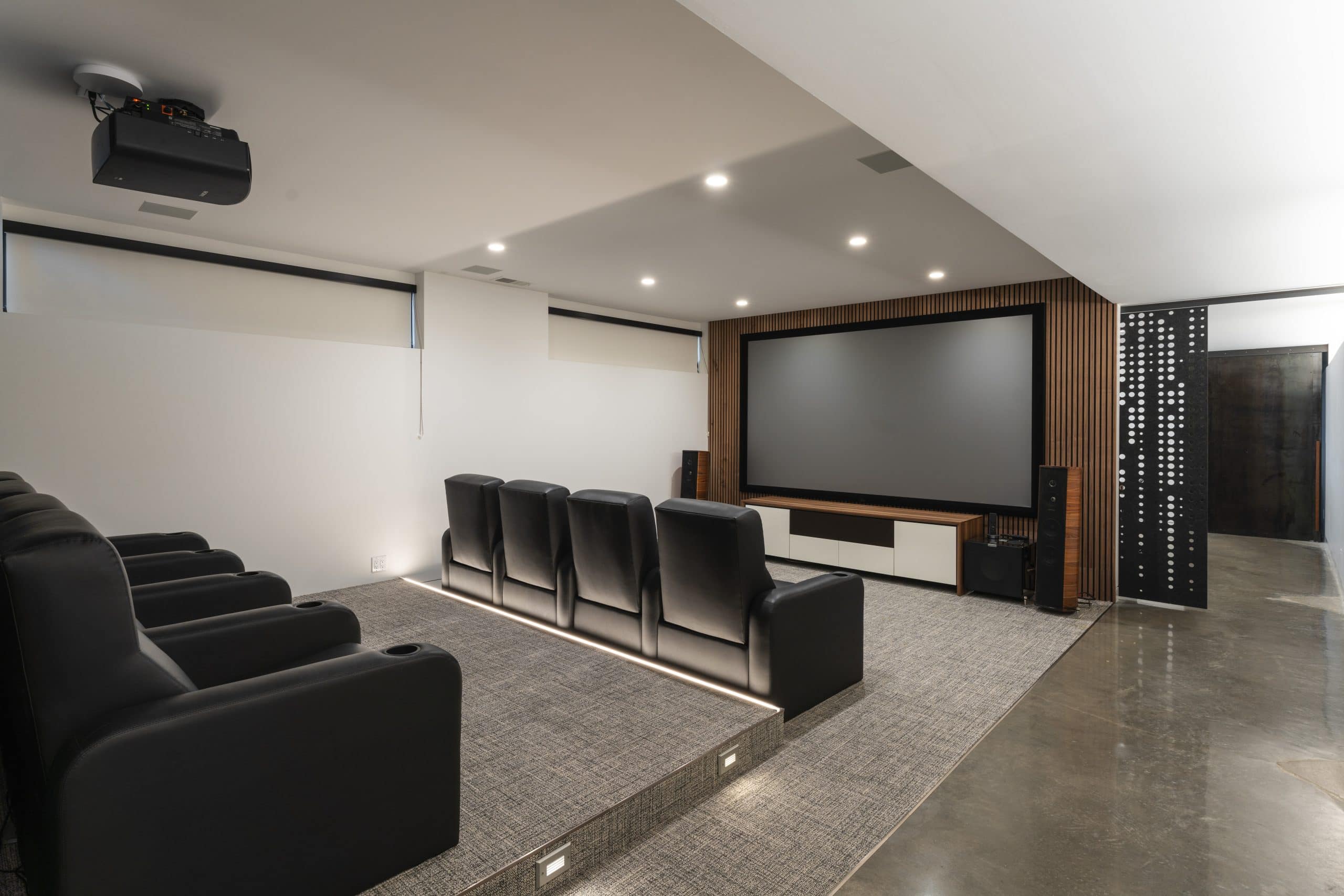media room in basement with large screen and projector for football watch parties or hosting made easy