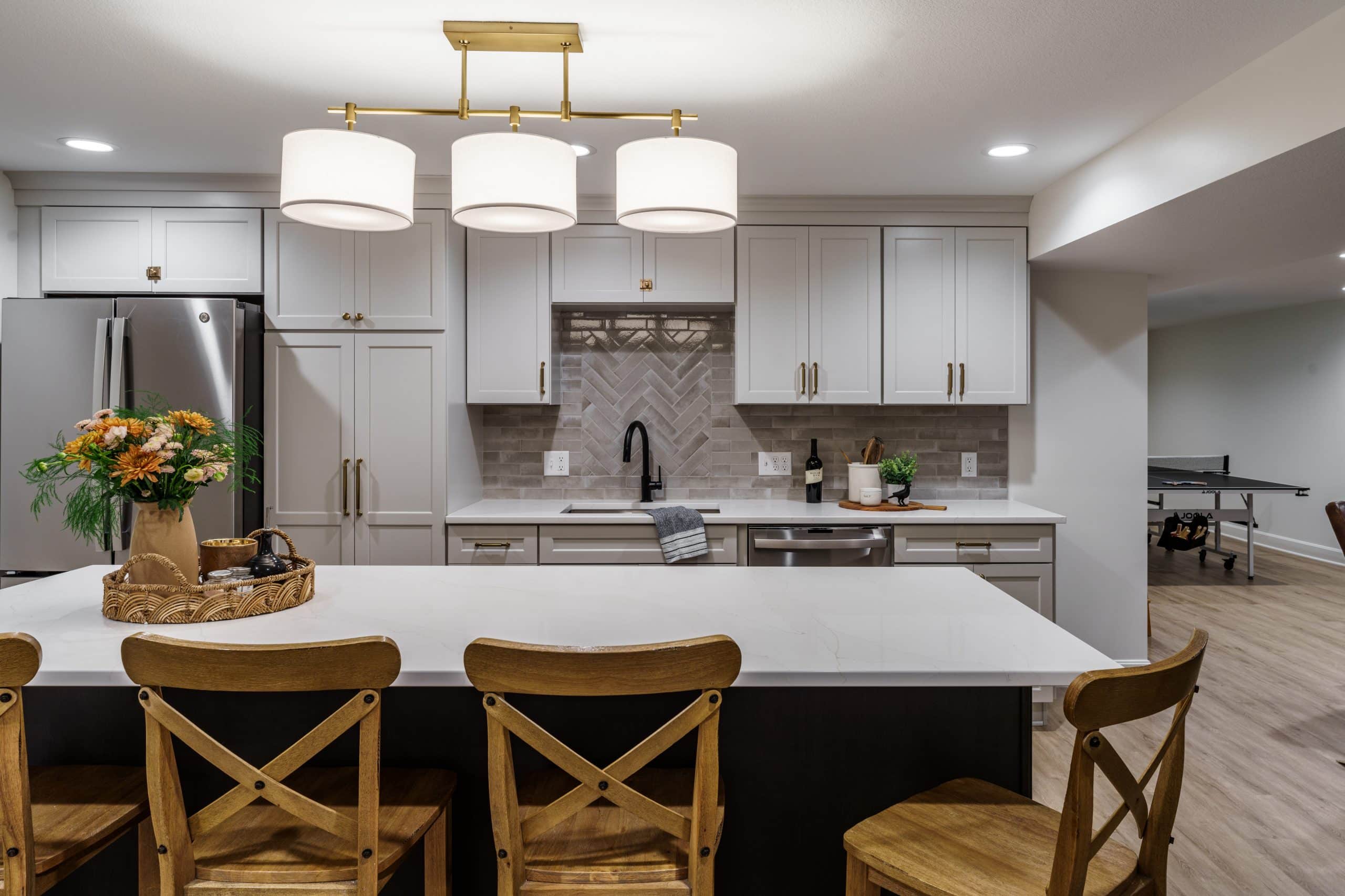 basement design with kitchen and various zones for hosting remodeled in kansas city by schloegel design remodel for a modern and cozy feel ideal for hosting guests during football season or for a movie or game night