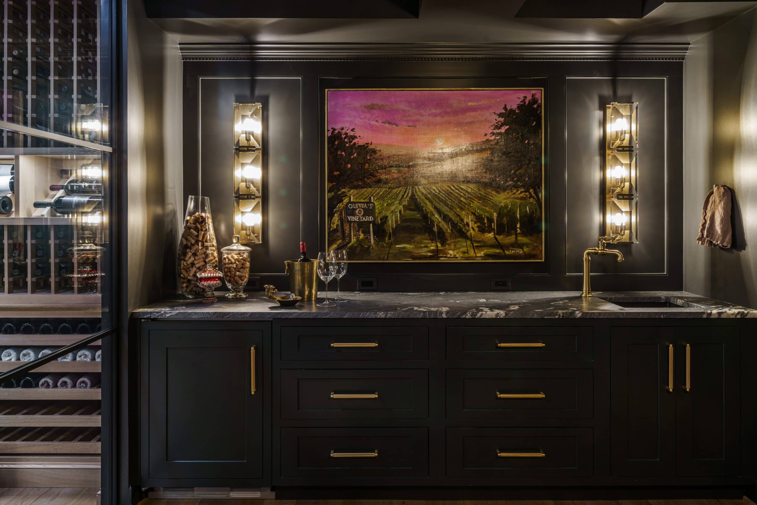 basement wine cellar and wet bar with dark iron ore custom cabinetry for moody design in kansas city missouri area