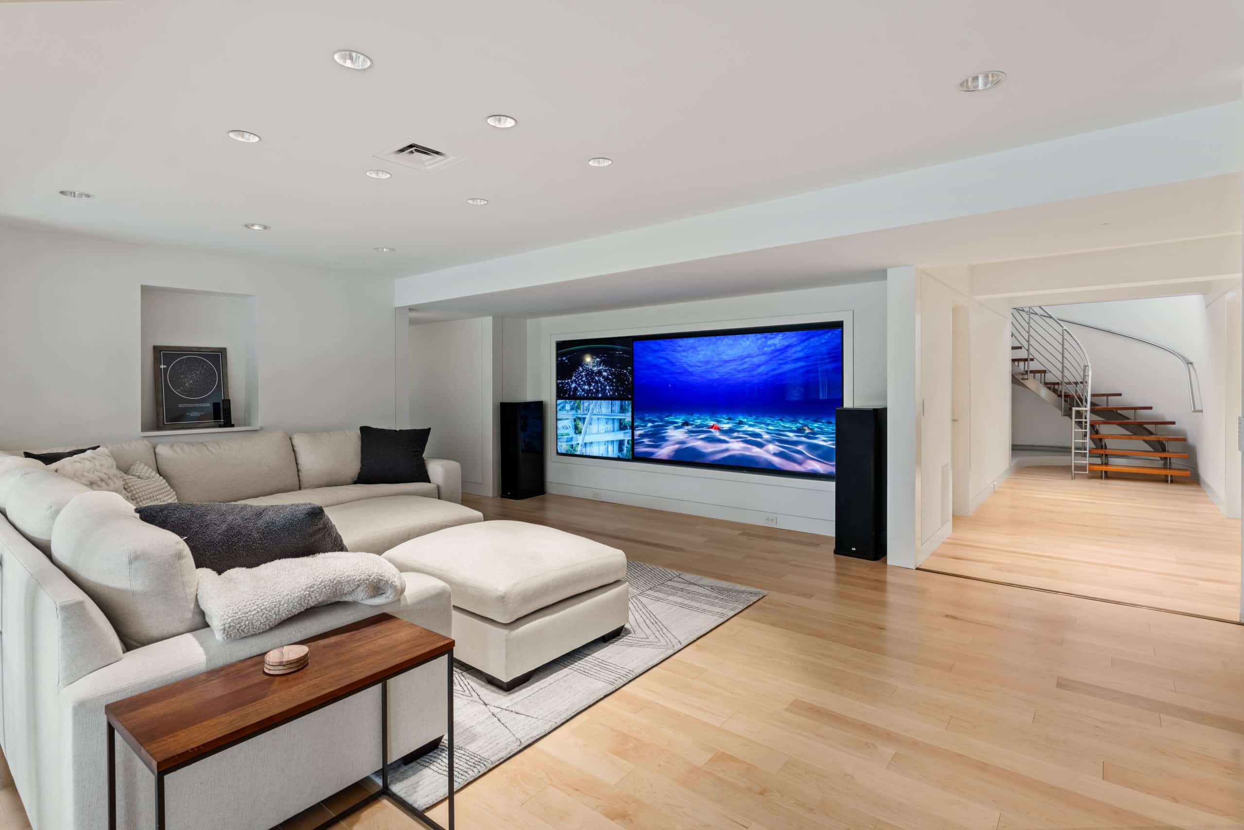 modern basement design with luxury media wall and multiple tvs for various games or views of plays during football season