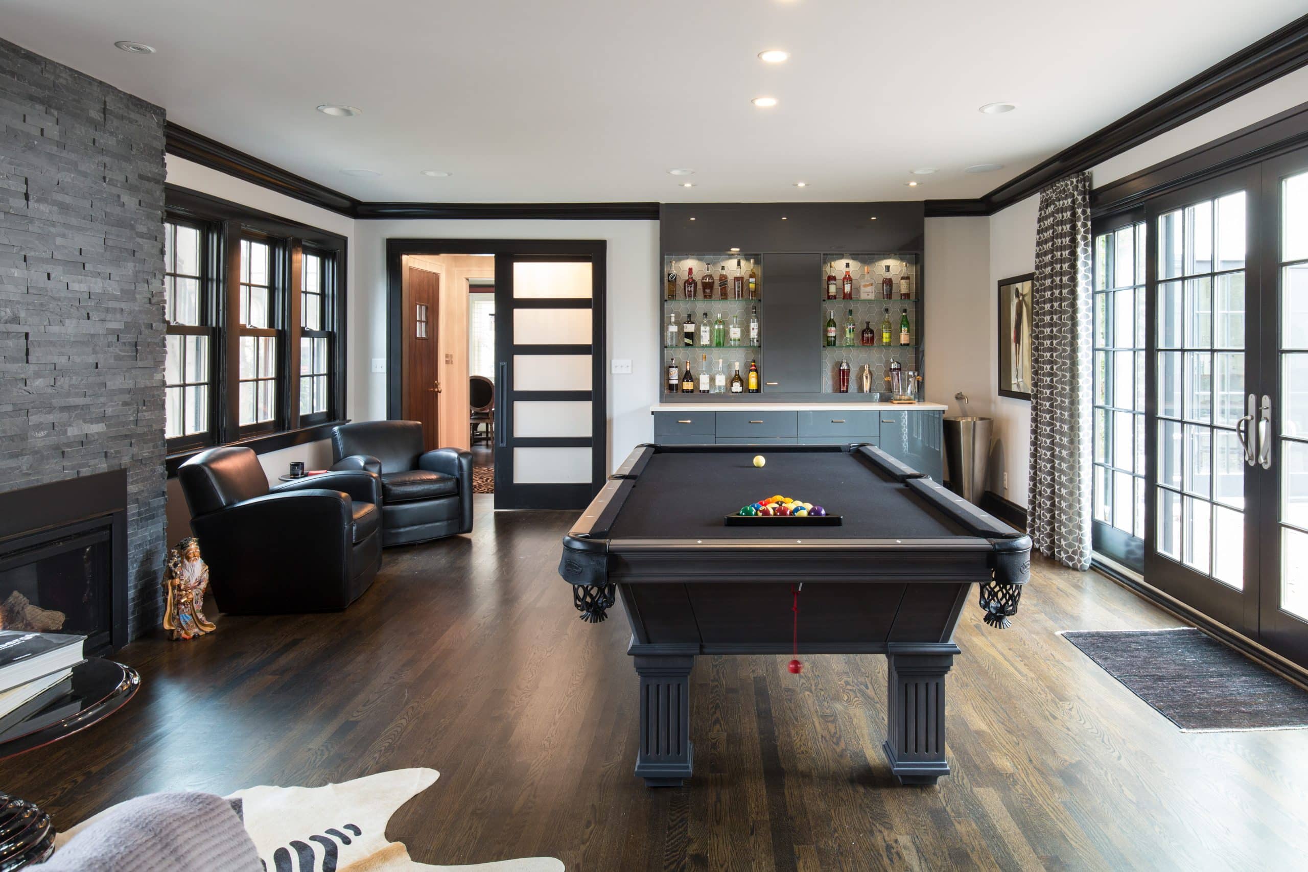 basement design with pool table game zone and wet bar and walk out perfect for hosting. designed by schloegel design remodel in kansas city missouri