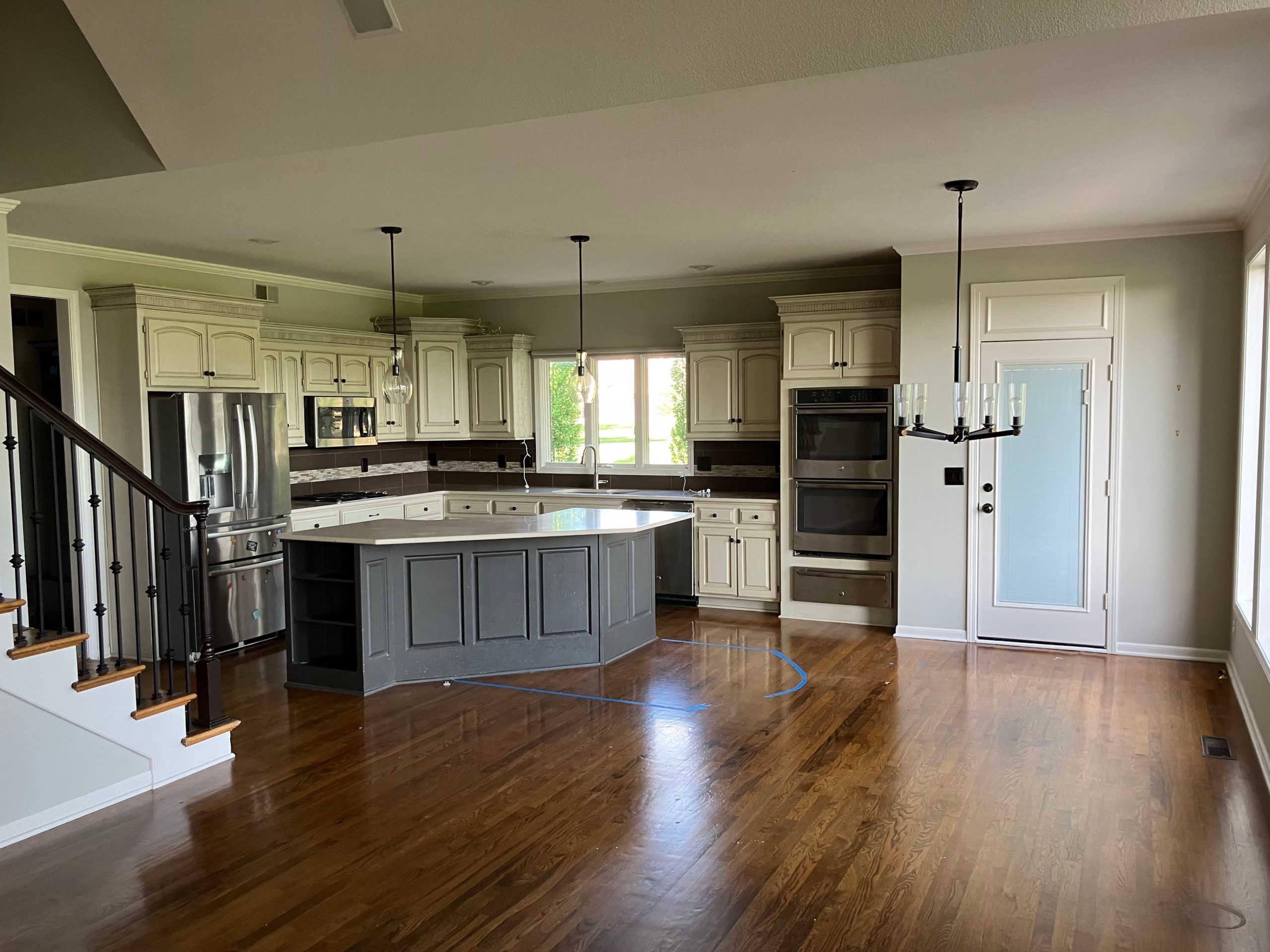 before photo of lenexa main floor with traditional and dated 1990's suburban details