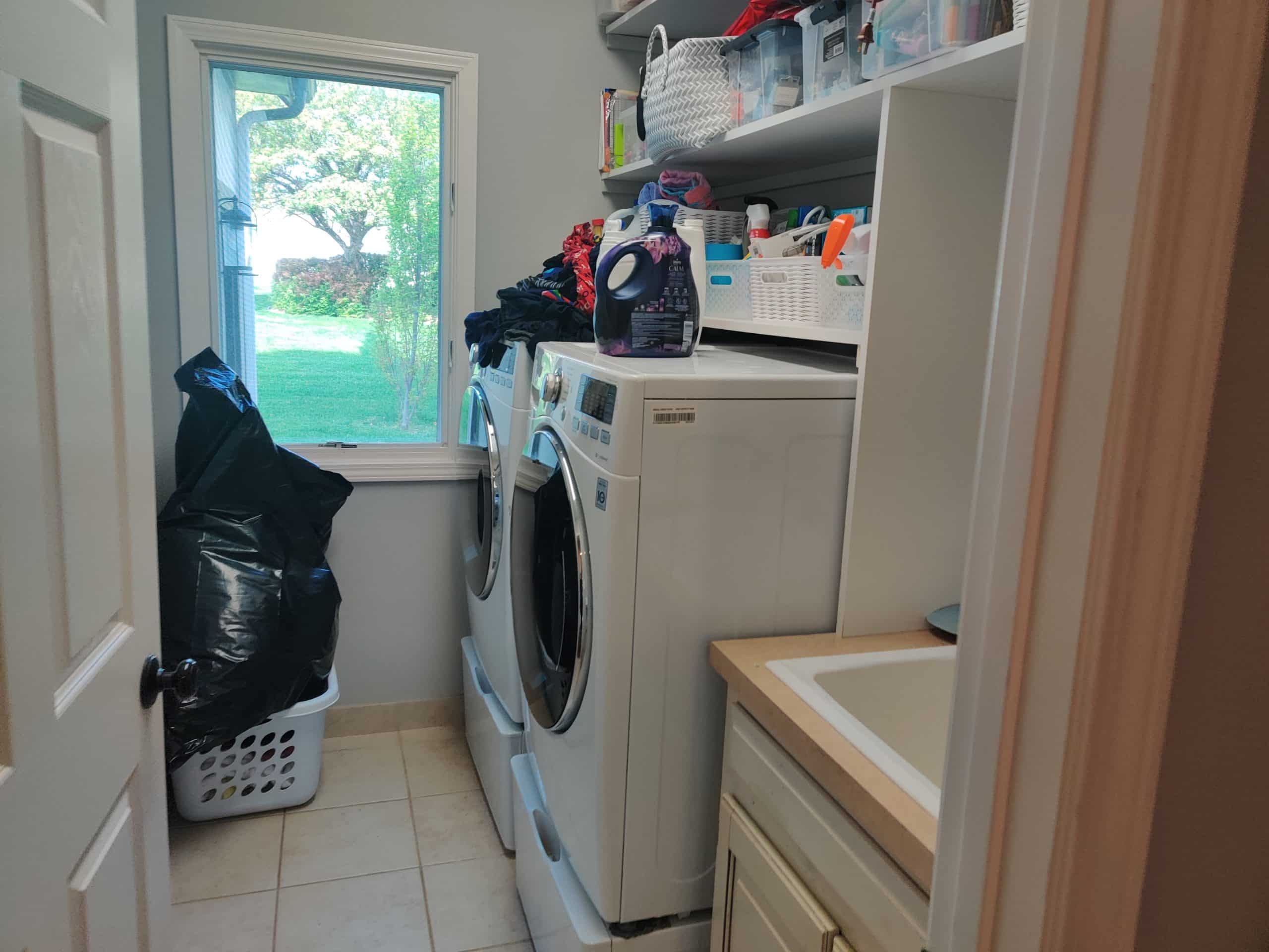 cramped and awkwardly placed laundry room on main floor before the remodel in this lenexa kansas home