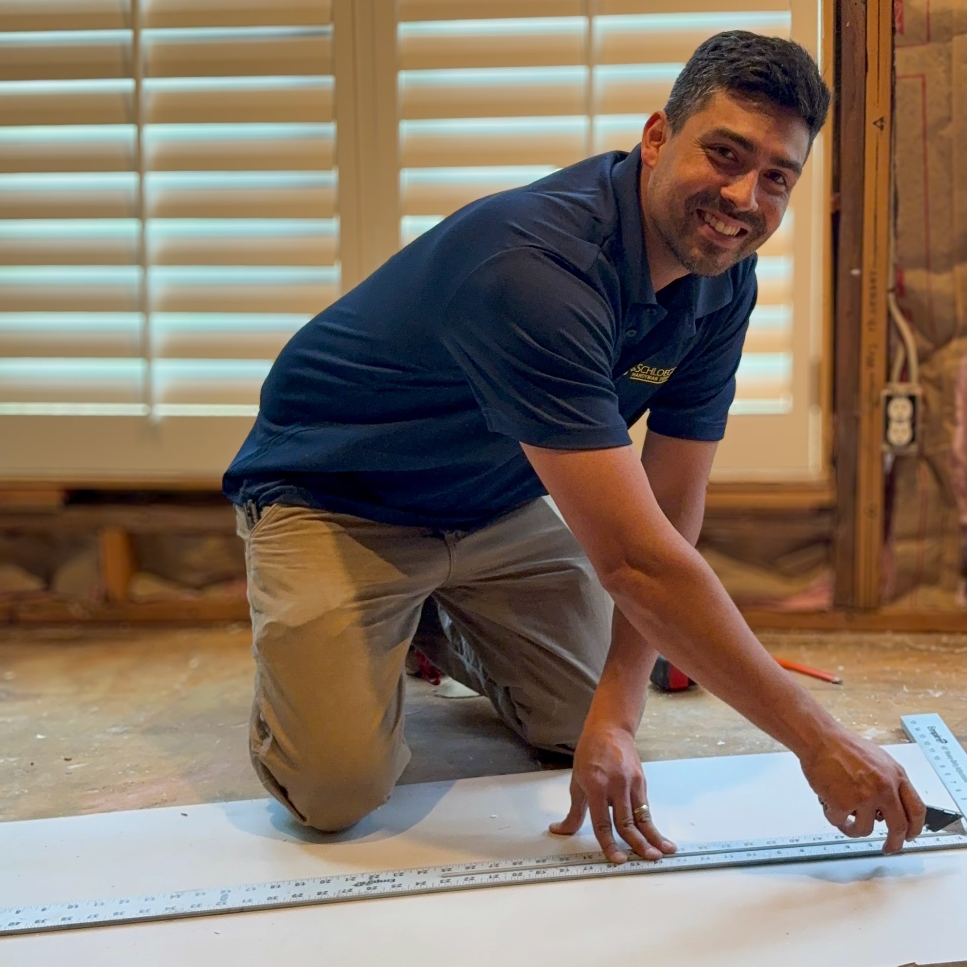 Handyman Technician cutting drywall Handyman Technician cutting drywall