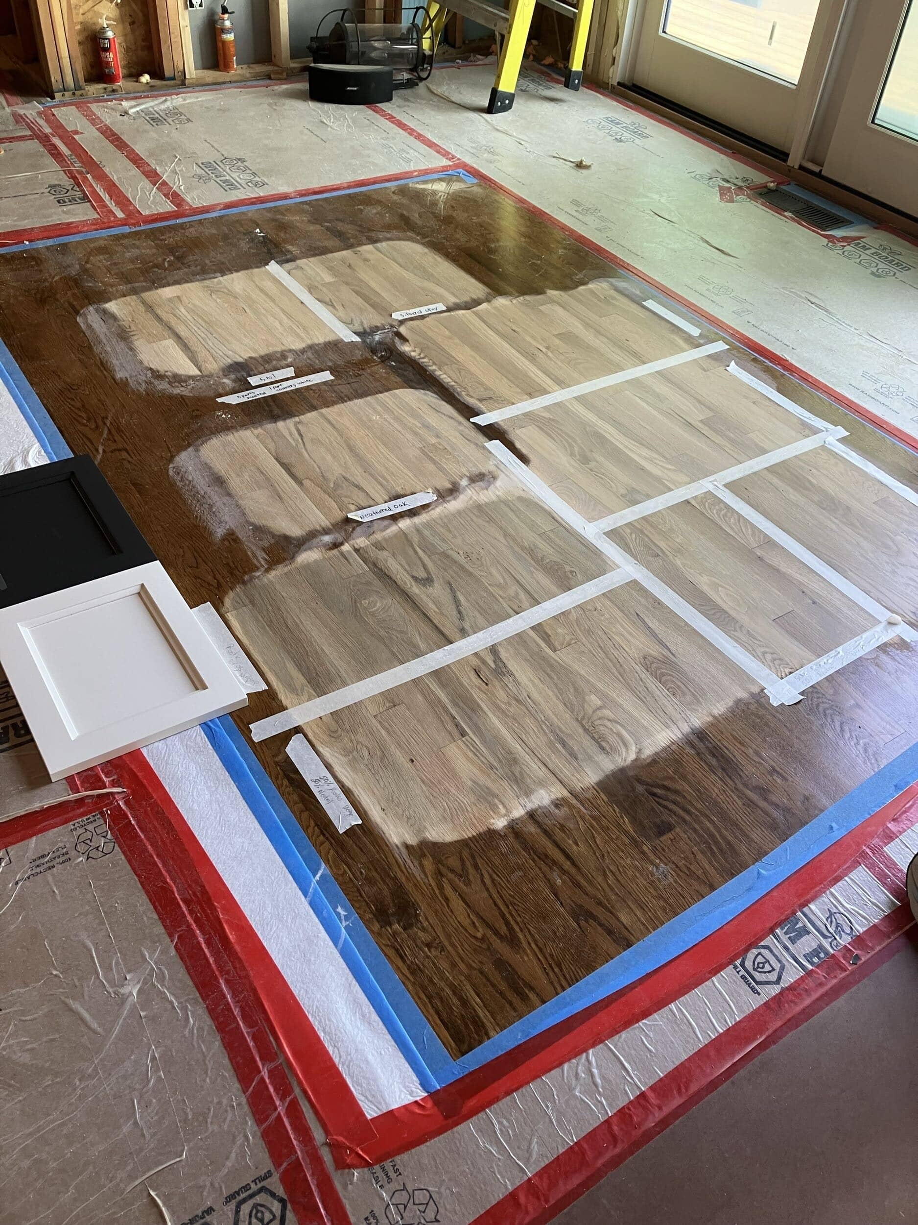 testing floor stain options planned out on the floor