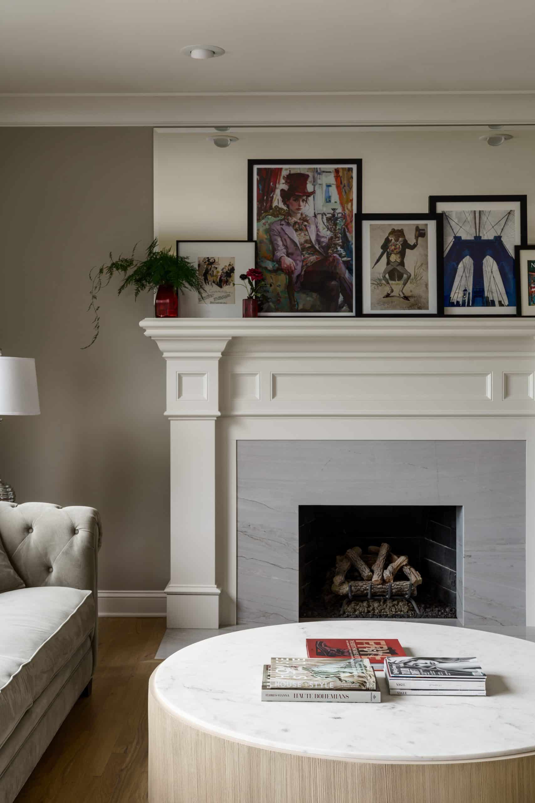 traditional fireplace with large format stone slab inset with thick moulding and trim and large mirror and unique art layered on mantle