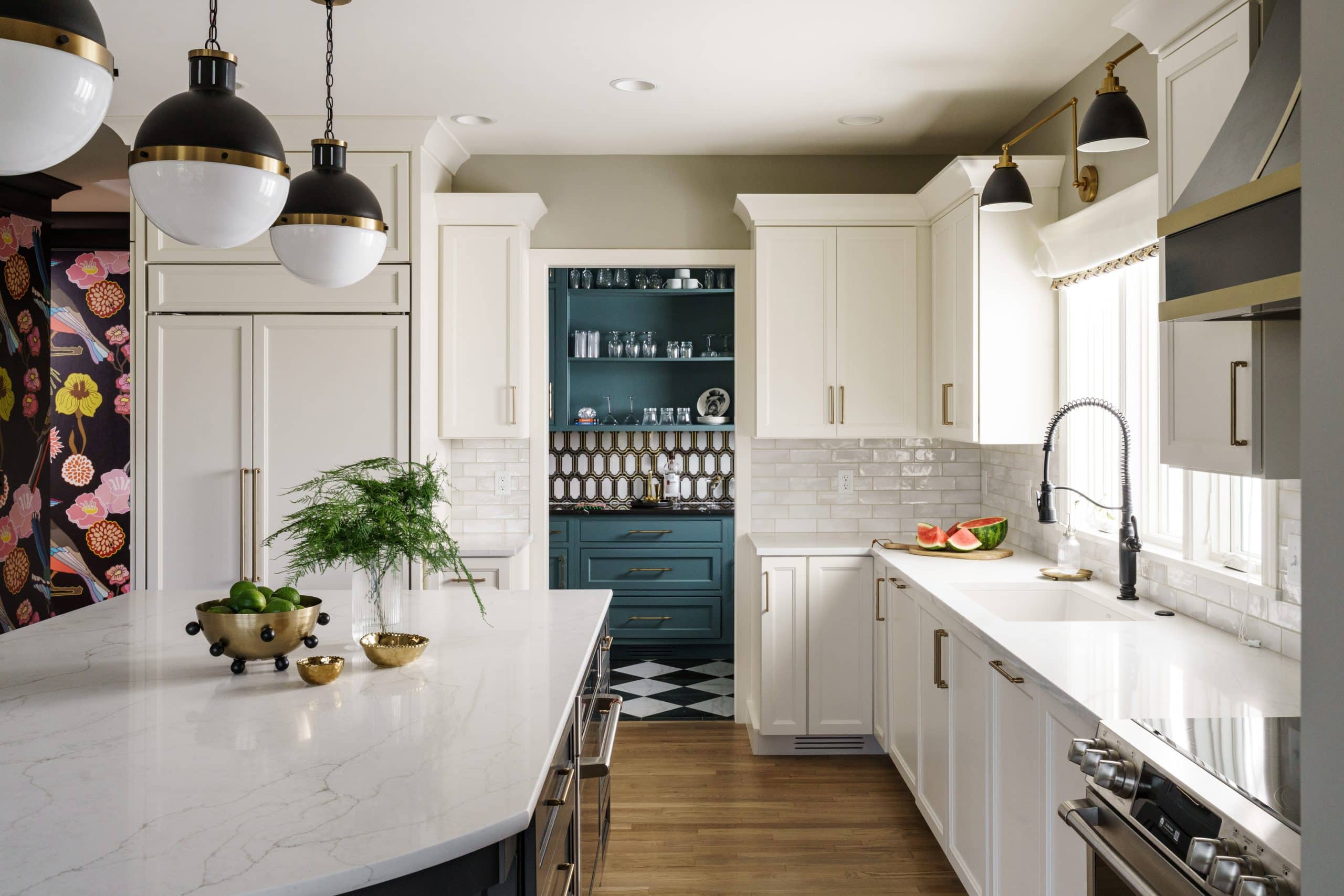 modern kitchen remodel in Lenexa kitchen with luxurious updated black and gold accents and a classic white kitchen feel with art deco inspired butler's pantry with statement teal cabinetry in that area