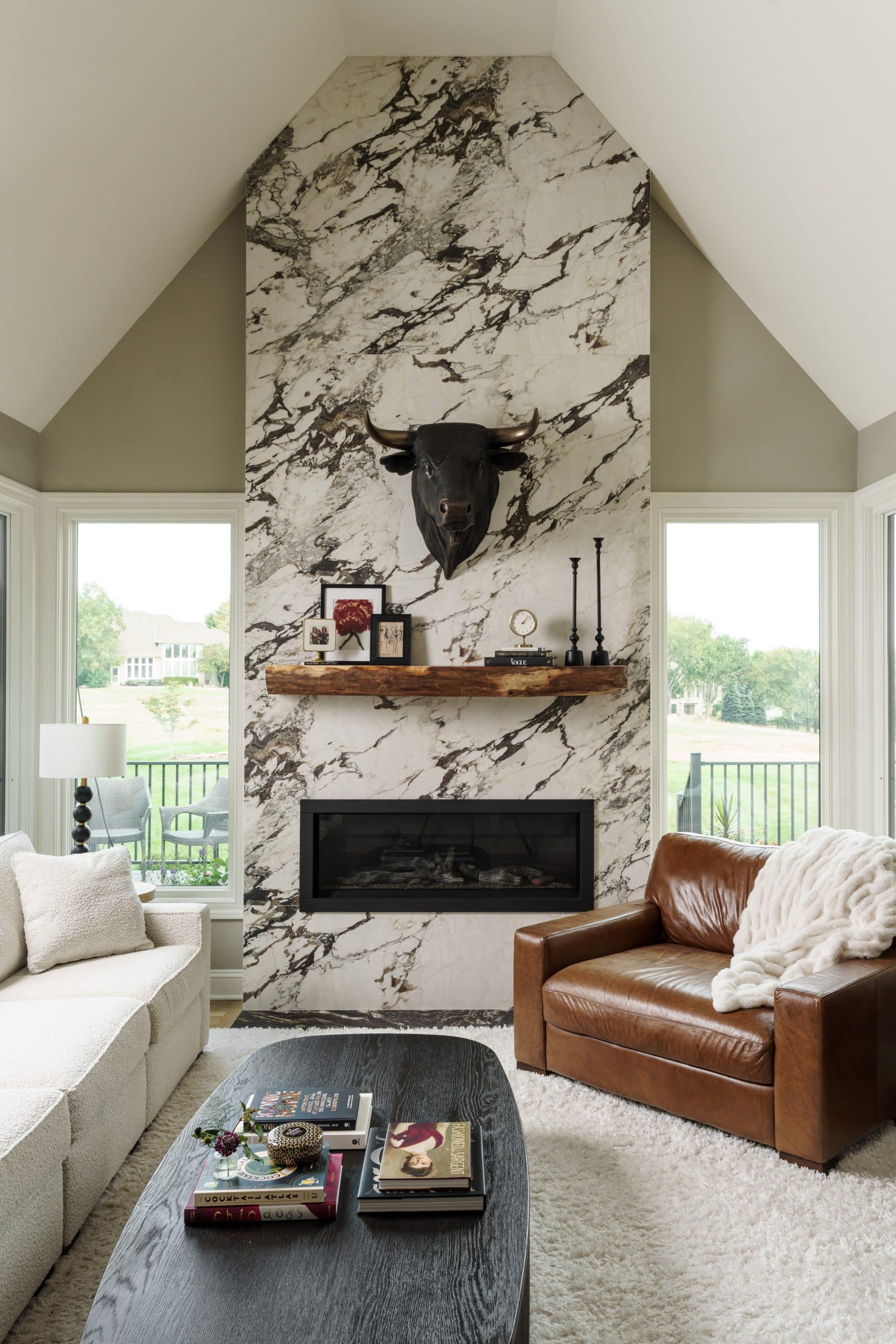 Window replacement flanking two sides of large format contemporary fireplace