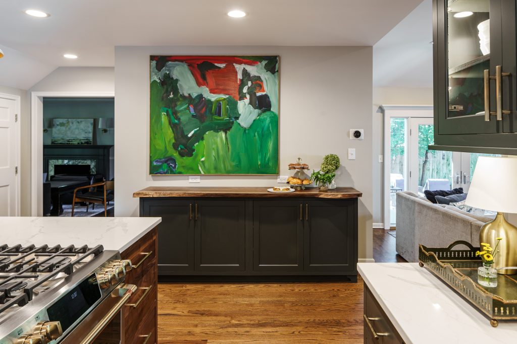 modern main floor remodel featuring a built in cabinet with a live edge oak top and unique abstract art piece with color hung above it