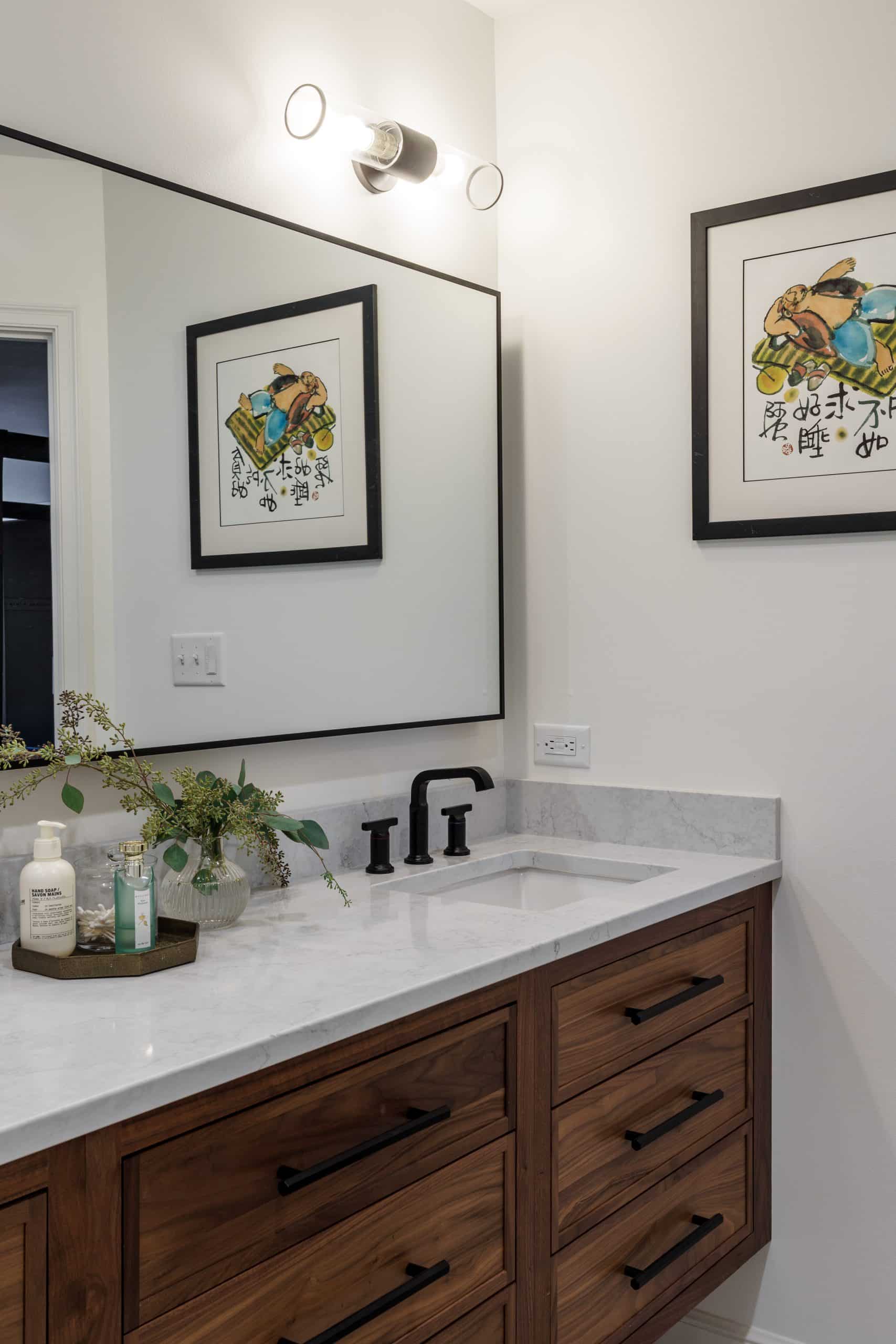 modern primary bathroom with warm stained wood vanity and creamy counters and black matte hardware and accents modern primary bathroom with warm stained wood vanity and creamy counters and black matte hardware and accents