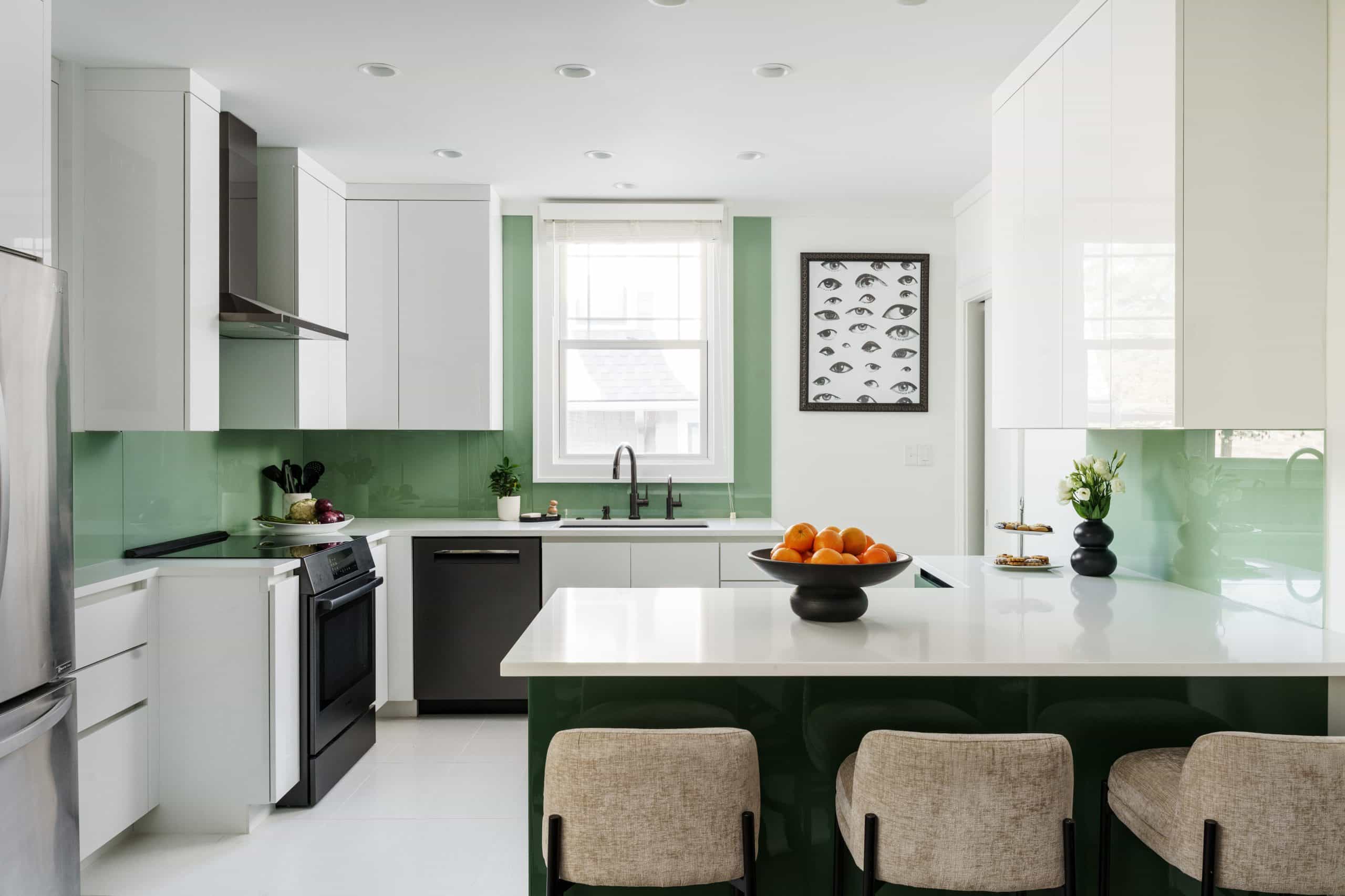 A high-design kitchen remodel in Brookside KCMO featuring custom high-gloss green cabinetry, sleek white upper cabinets, and a minimalist white island. The European-inspired space includes integrated appliances and a bright, airy layout.