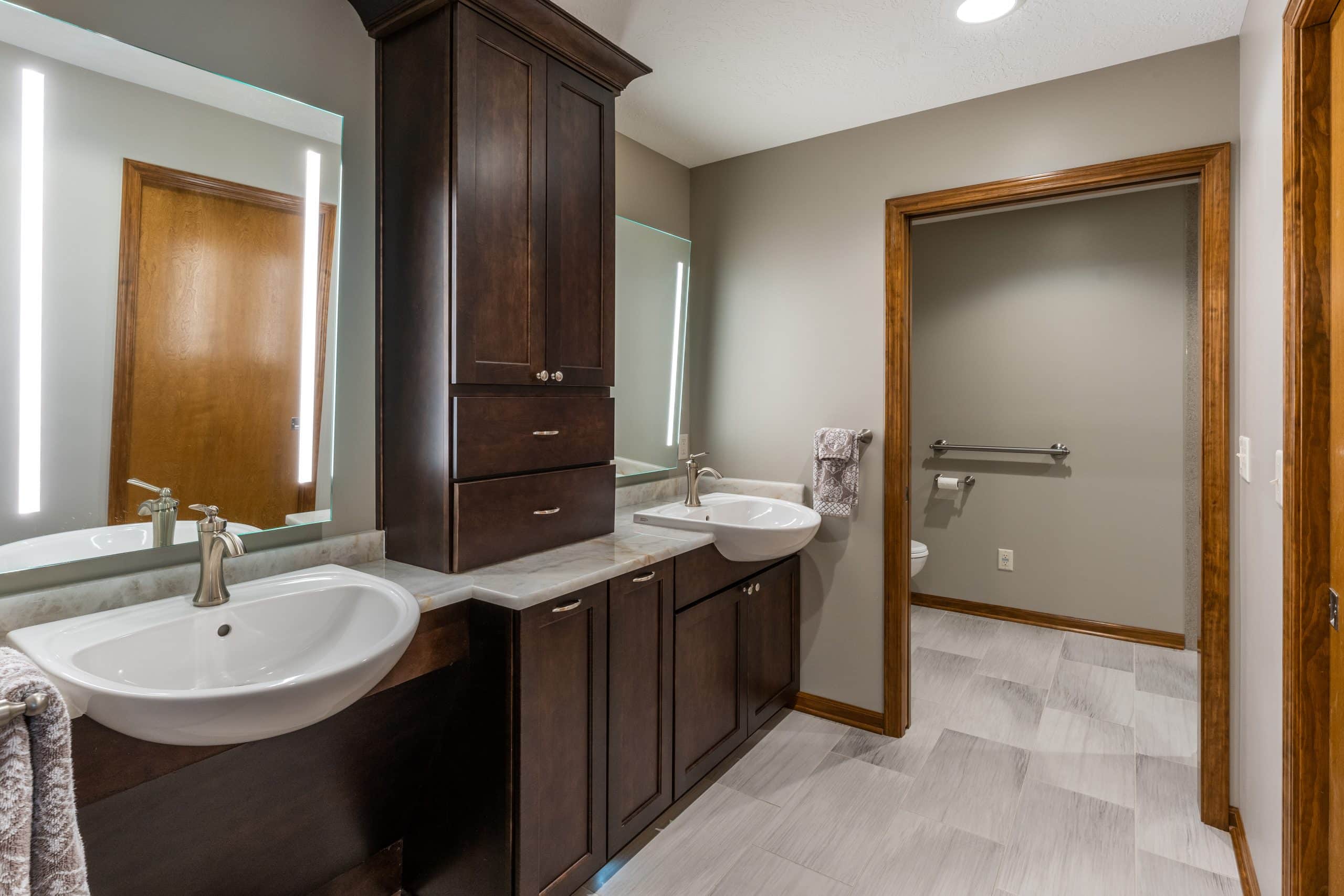 Accessible bathroom with dark stained cabinets Accessible bathroom with dark stained cabinets