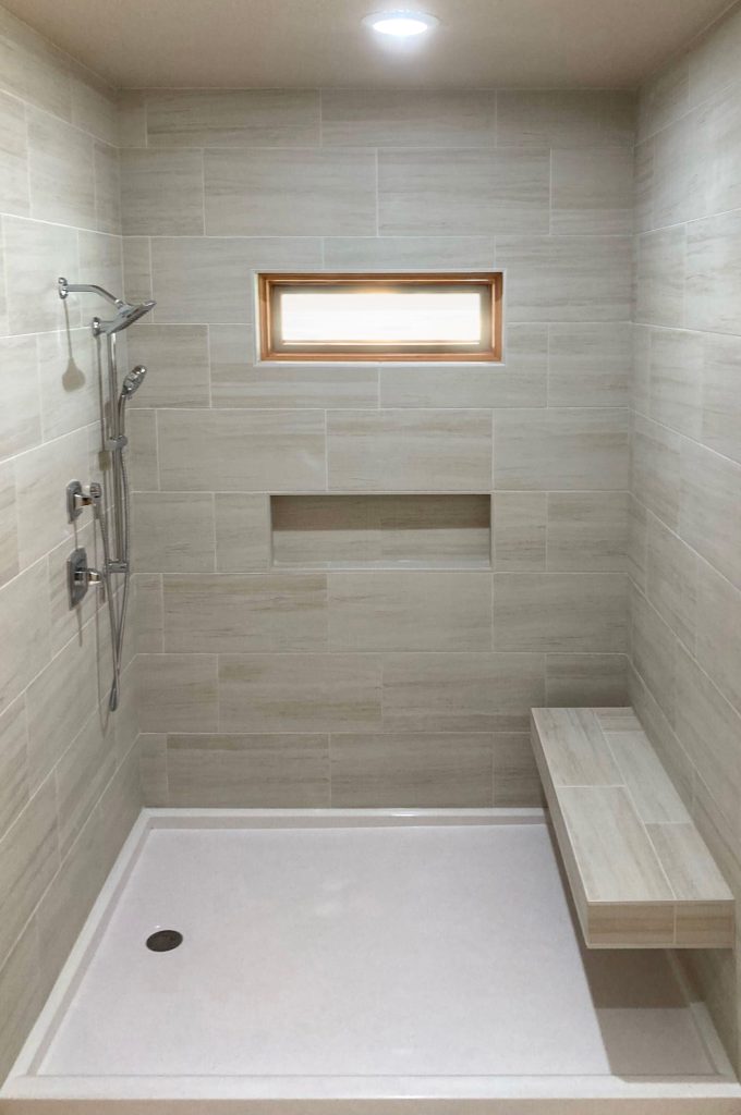 shower with bench and window and niches