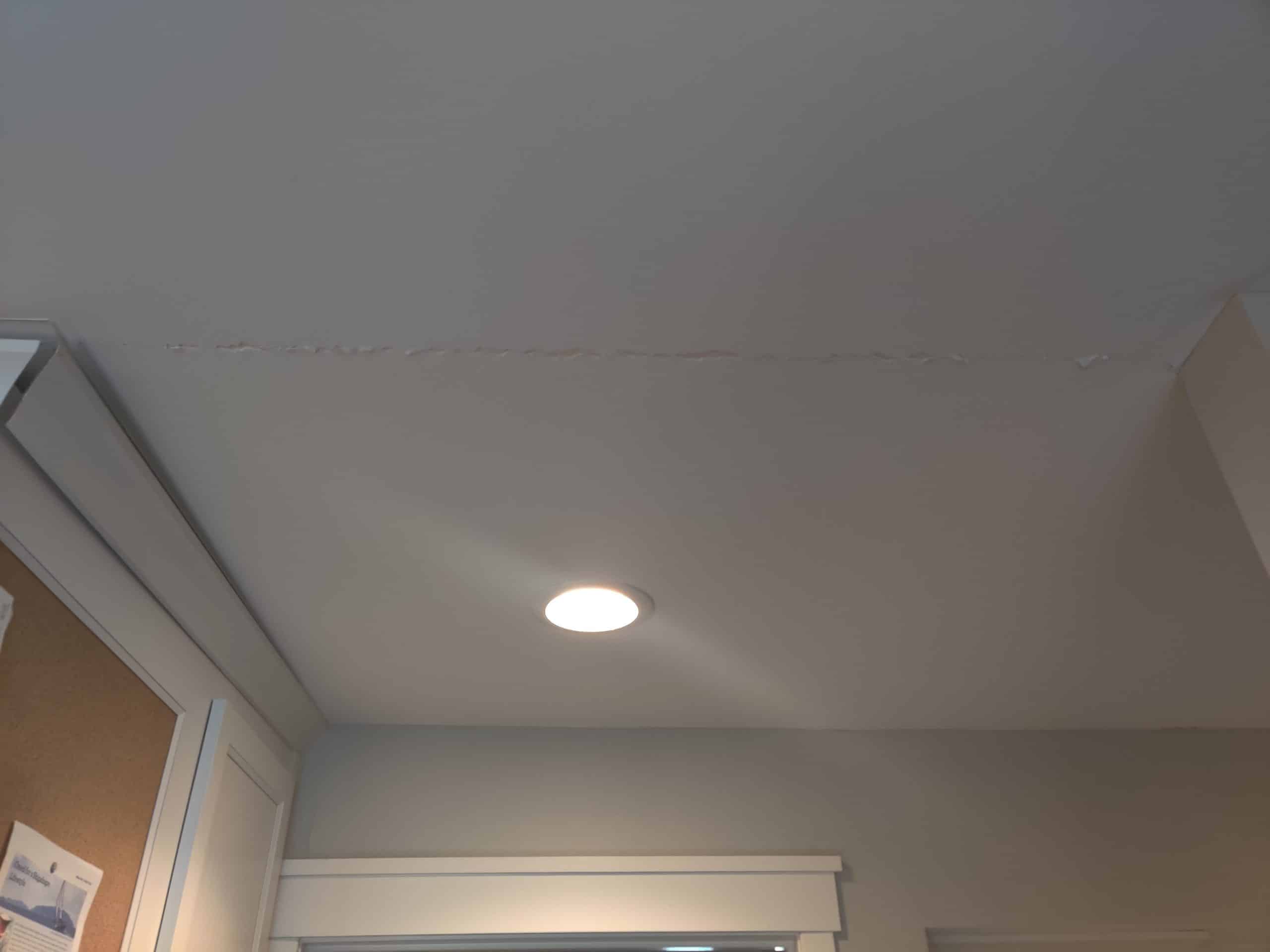 cracked ceiling and trim cracking from tree damage during Leawood storm causing structural issues in a home leading to a remodel