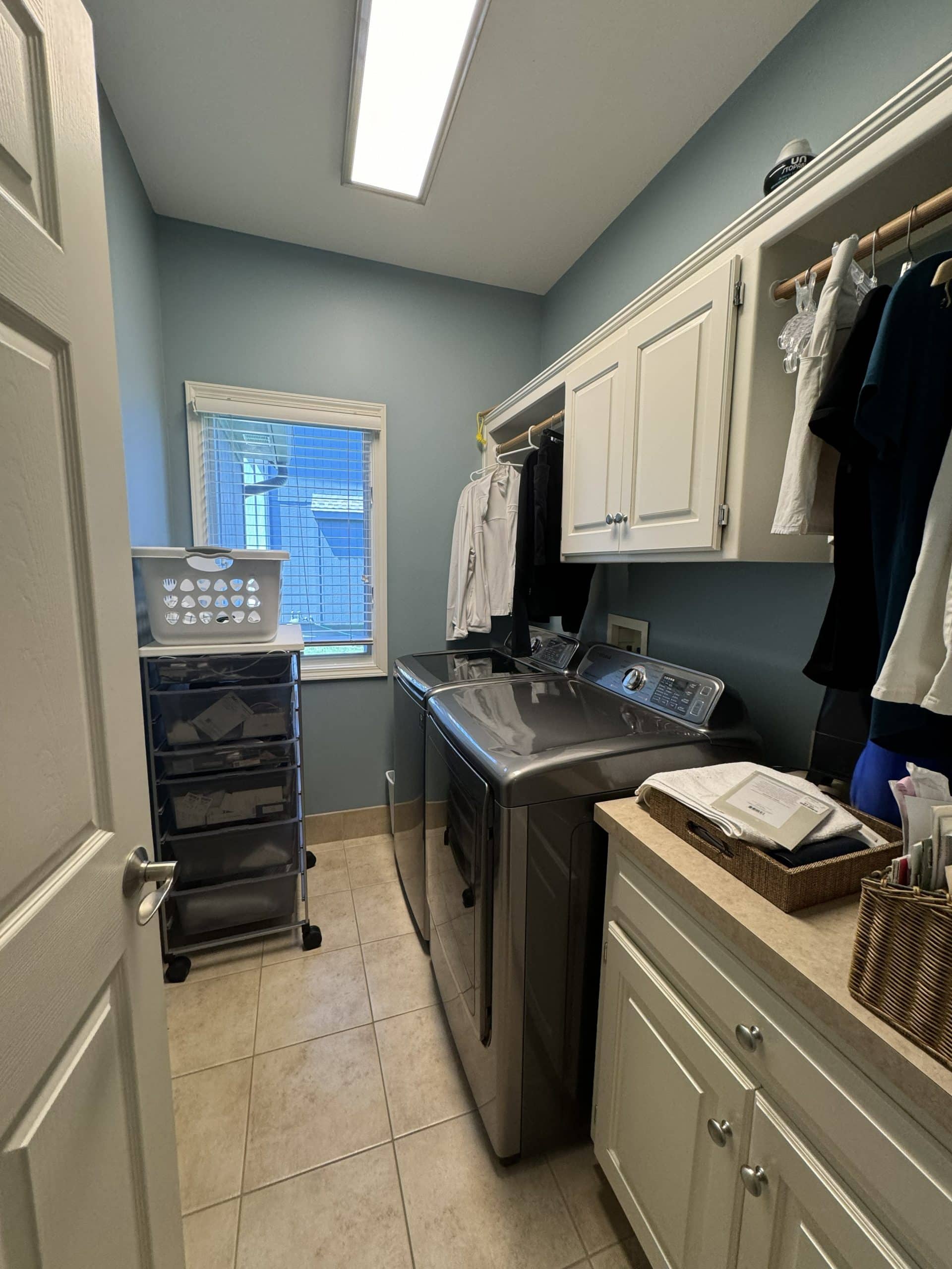 Laundry room before with side by side washer and dryer