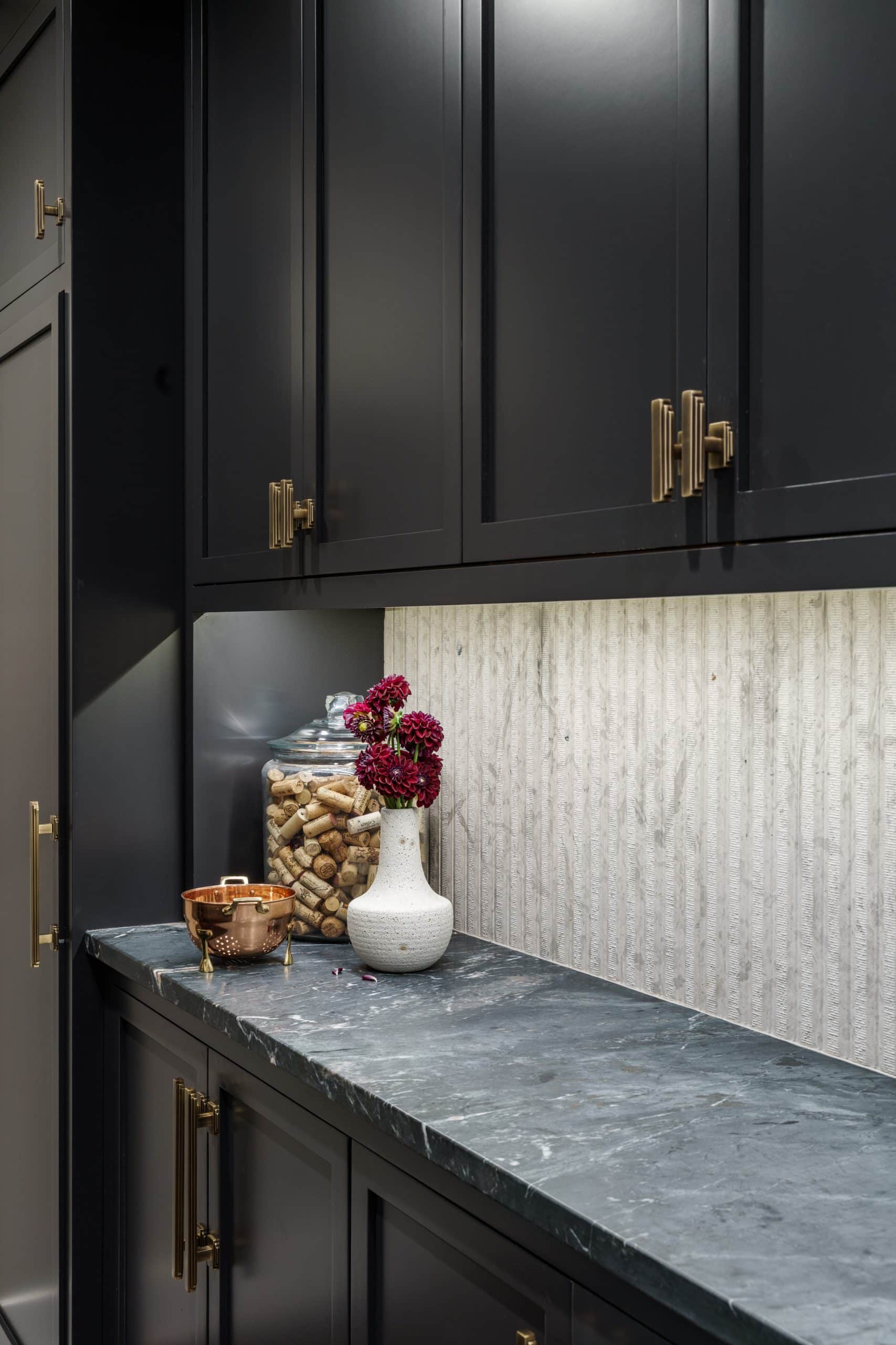 detail shot of Moody glam butler's pantry remodel in Leawood detail shot of Moody glam butler's pantry remodel in Leawood with fluted backsplash and art deco inspired gold hardware