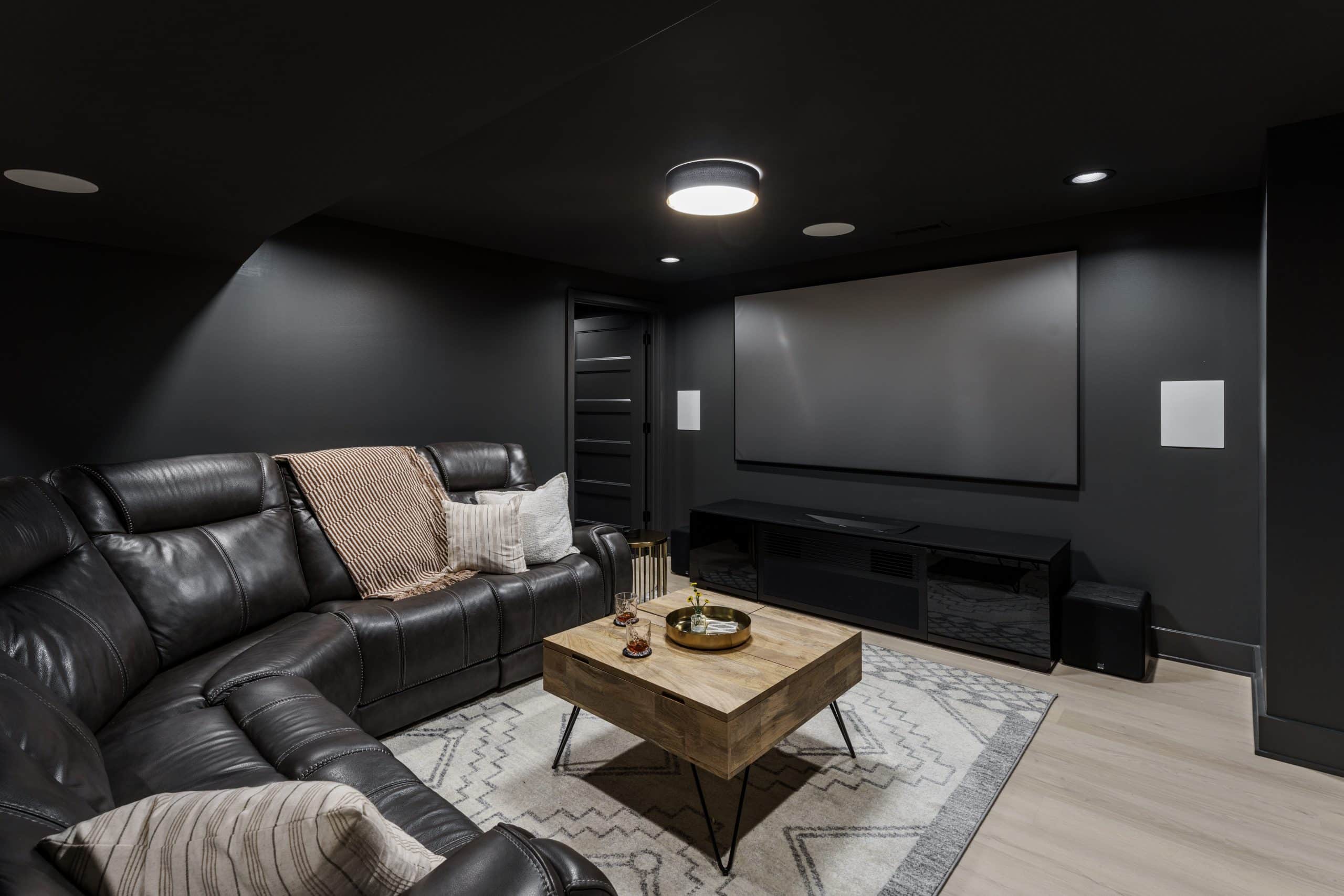 moody modern basement living room moody modern basement remodel with deep iron ore color drenching and white bright oak inspired LVT floors