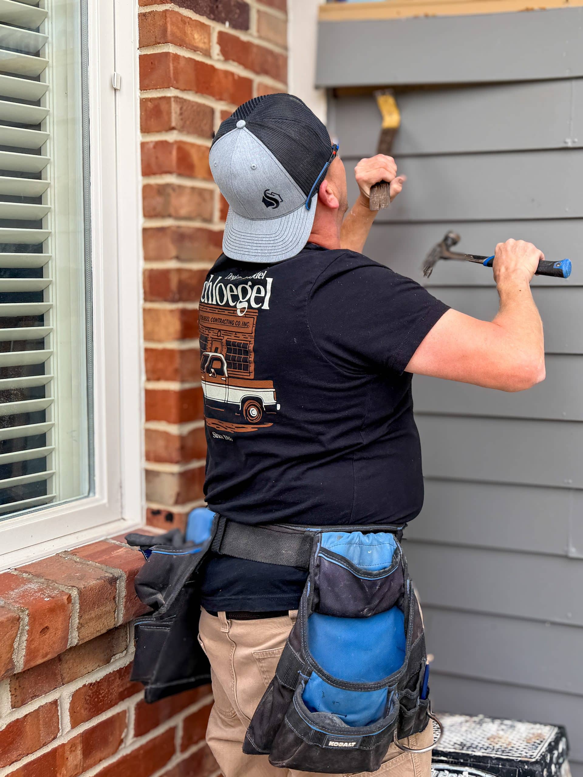 Handyman removing old siding
