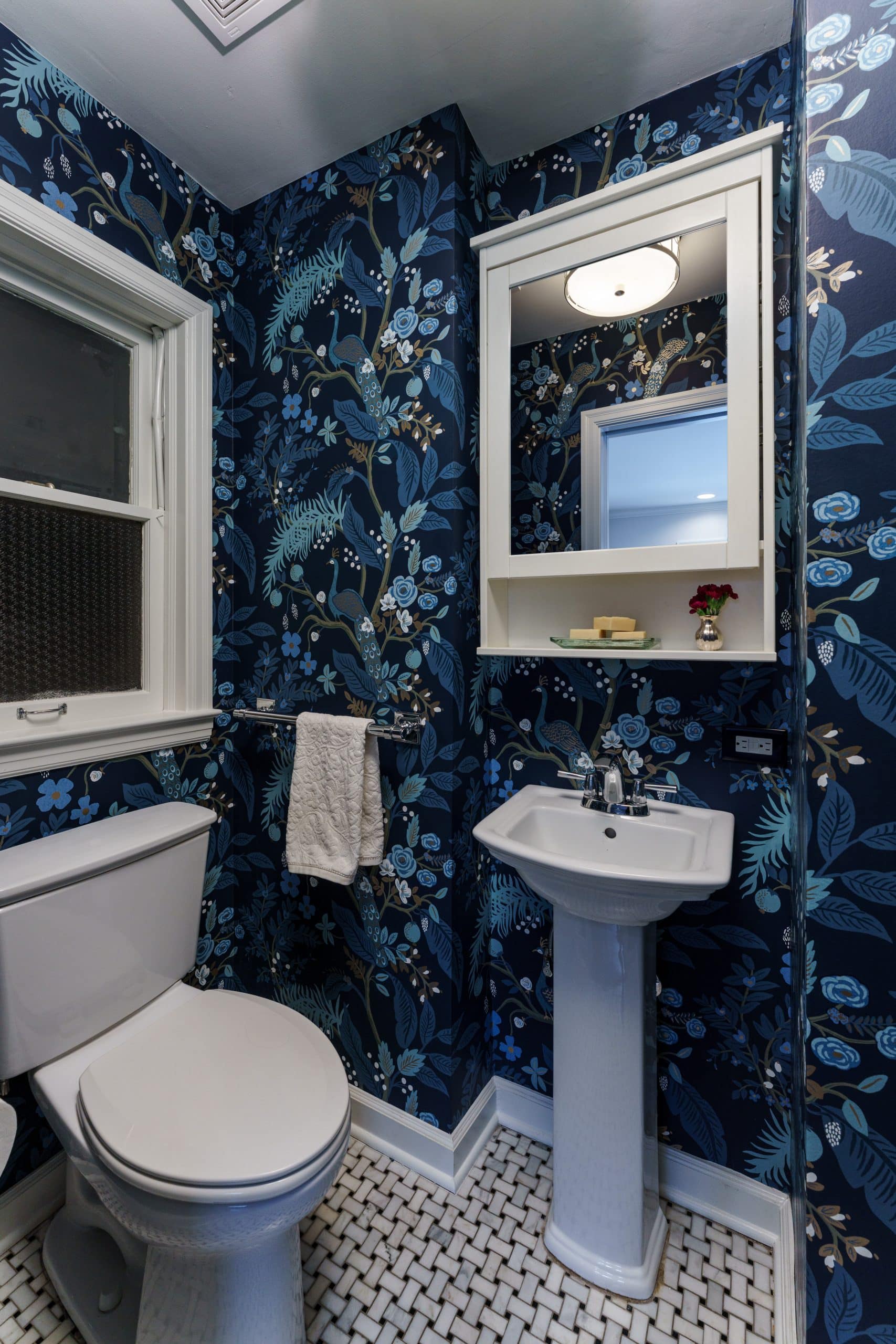 bold blue floral wallpaper in small powder bath for classic design with vintage hints