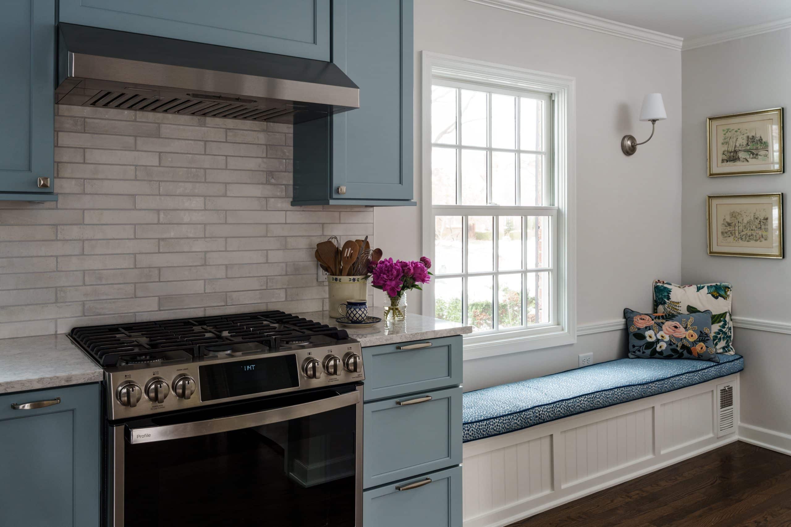 powder blue kitchen cabinets and built-in shelf with custom blue cushion