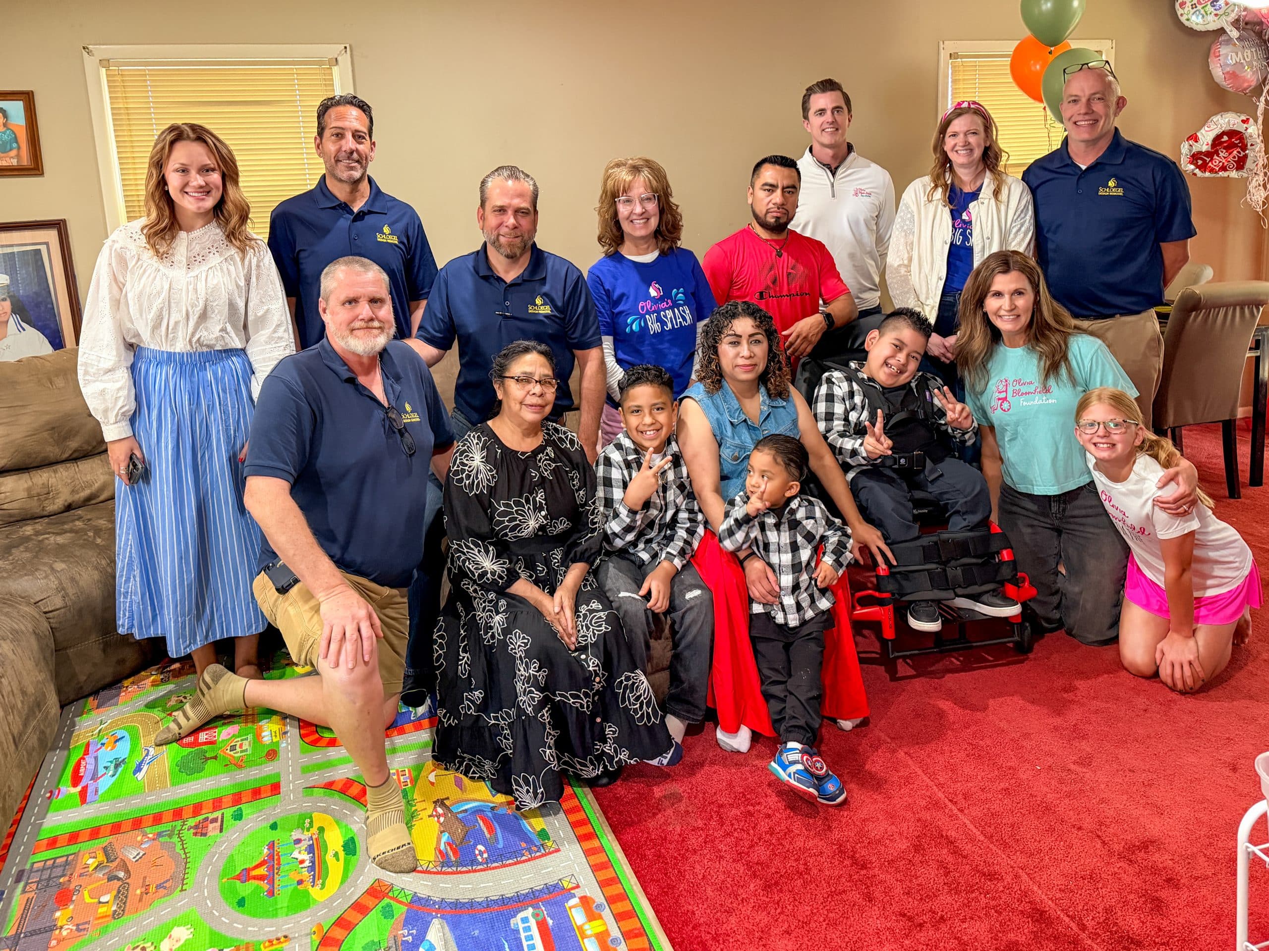 Schloegel Design Remodel team with big splash recipient family and Olivia Bloomfield Foundation family after accessible bathroom remodel reveal Schloegel Design Remodel team with big splash recipient family and Olivia Bloomfield Foundation family after accessible bathroom remodel reveal