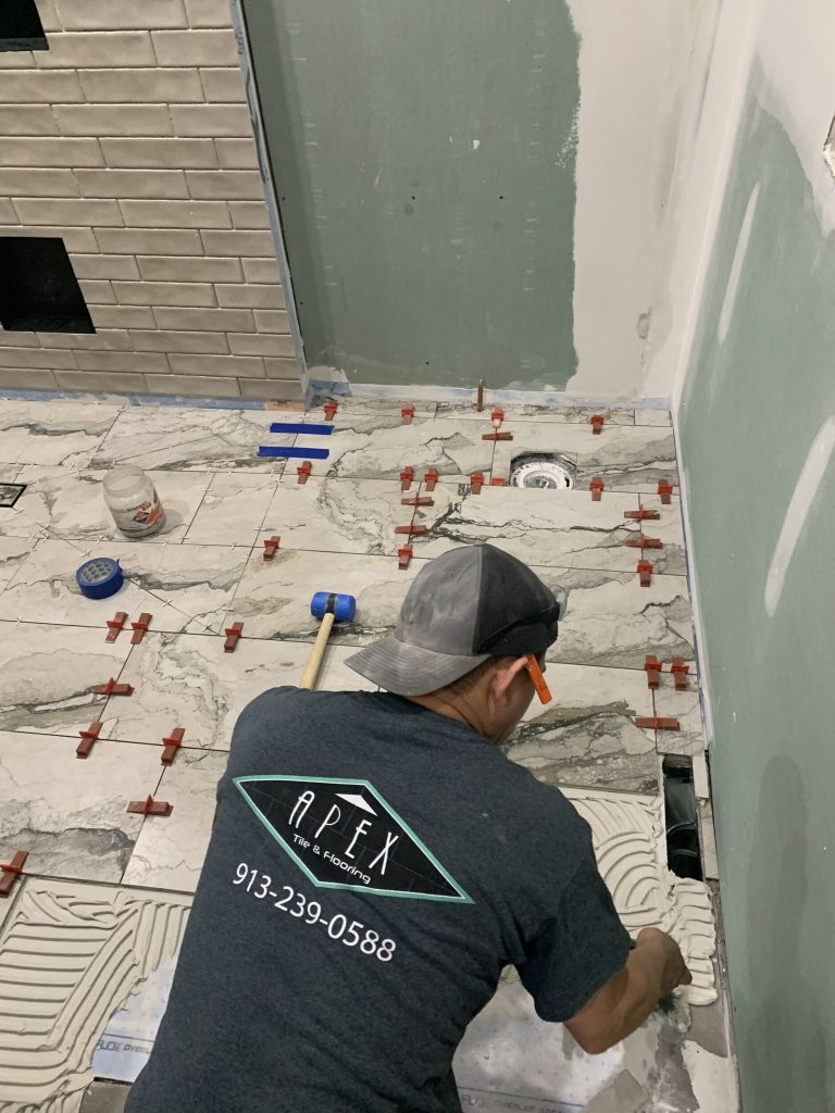 laying floor tile in the accessible bathroom remodel