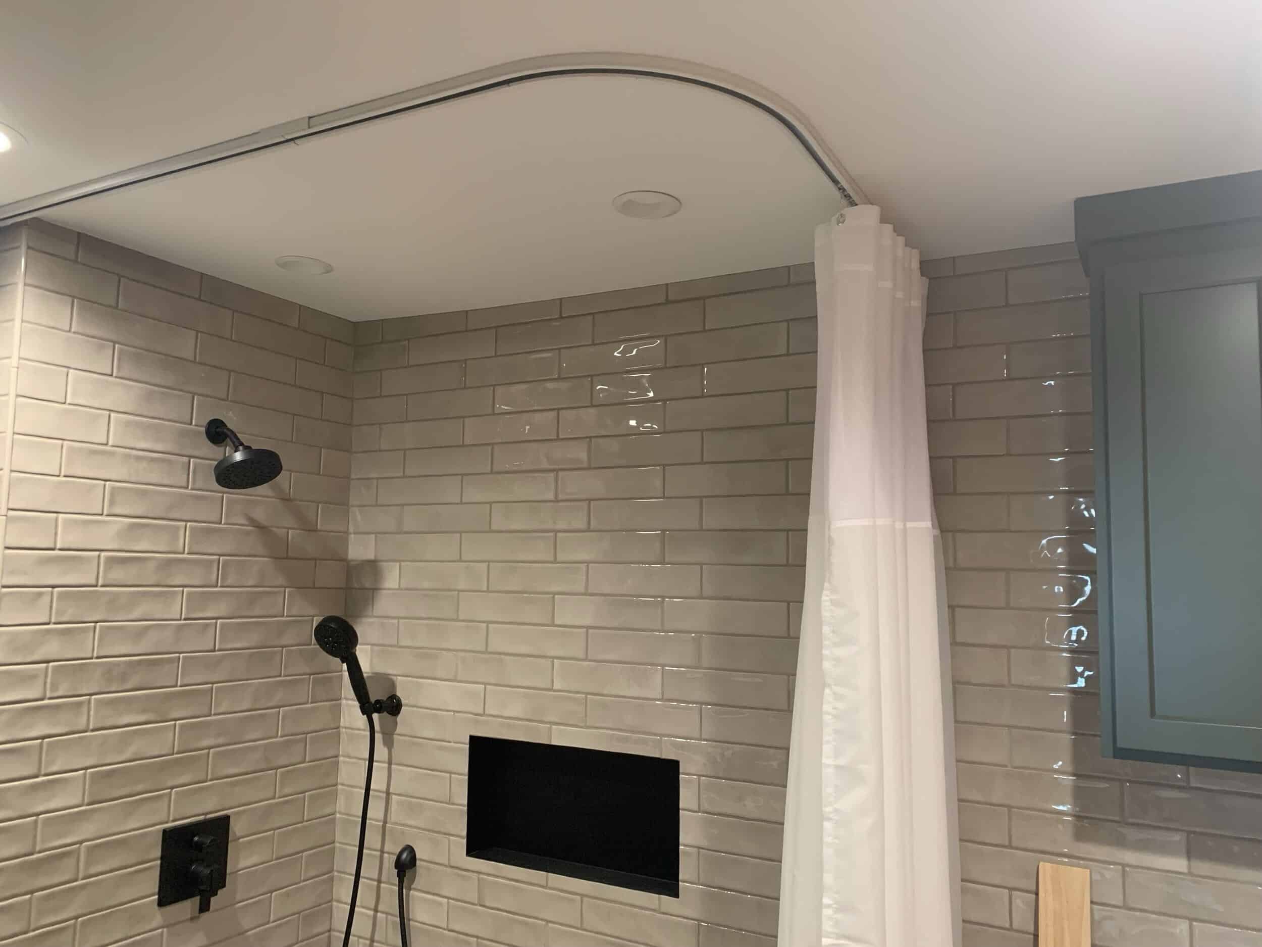 ceiling shower curtain installed and matte black shower hardware