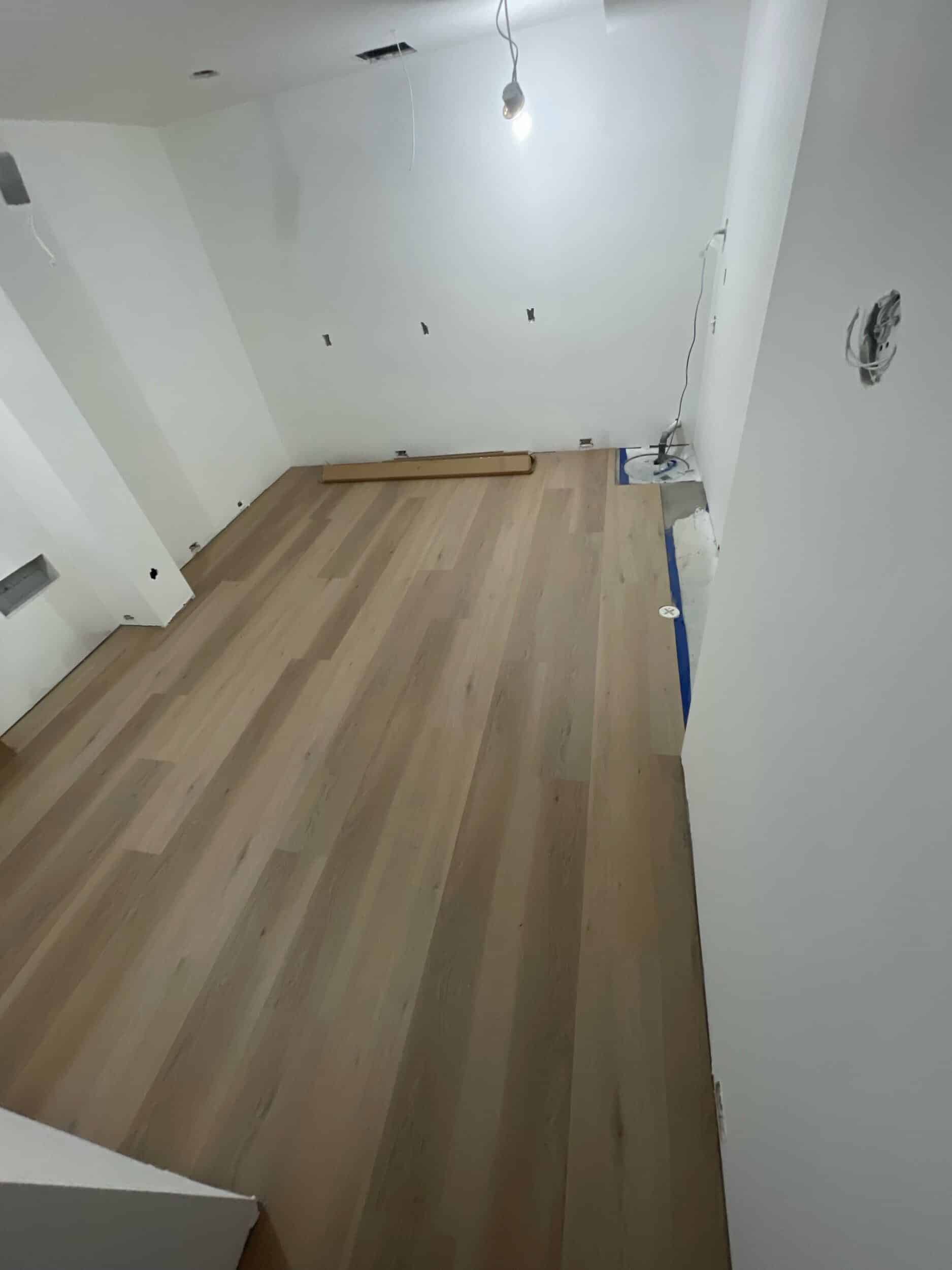 new LVP flooring installed in home basement gym remodel in Cedar Creek, Olathe with white oak finish and looks liker real hardwoods