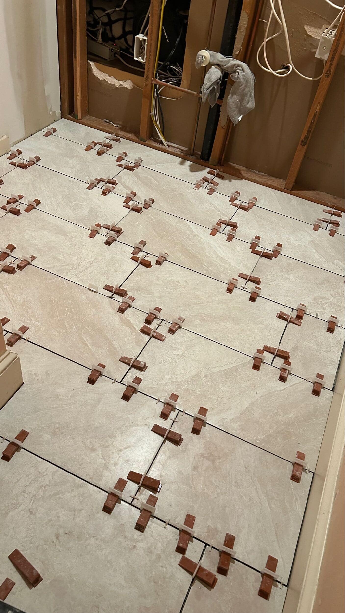 laying new floor tile in Prairie Village hall bathroom remodel